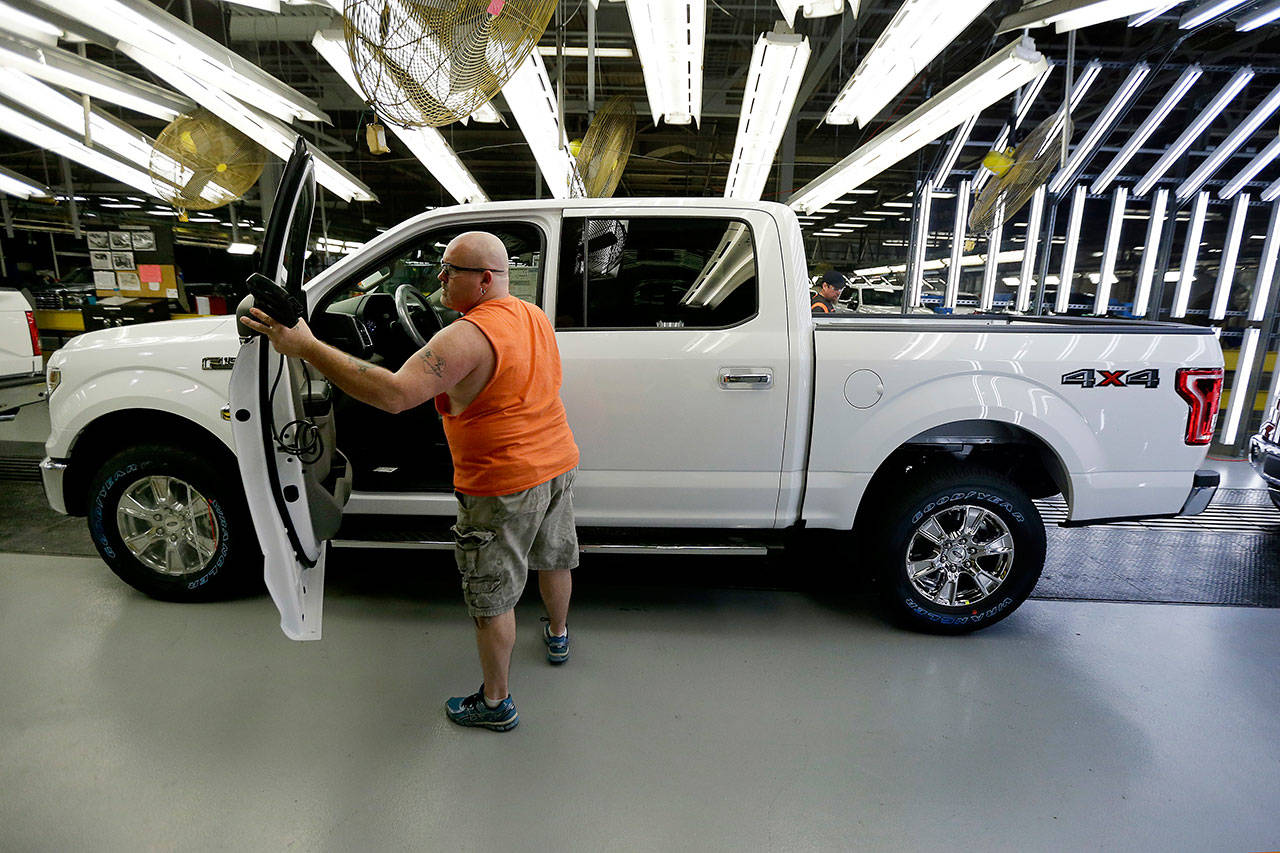 <strong>Charlie Riedel</strong>/The Associated Press In this March 13, 2015, file photo a worker inspects a new 2015 aluminum-alloy body Ford F-150 truck at the company’s Kansas City assembly plant.