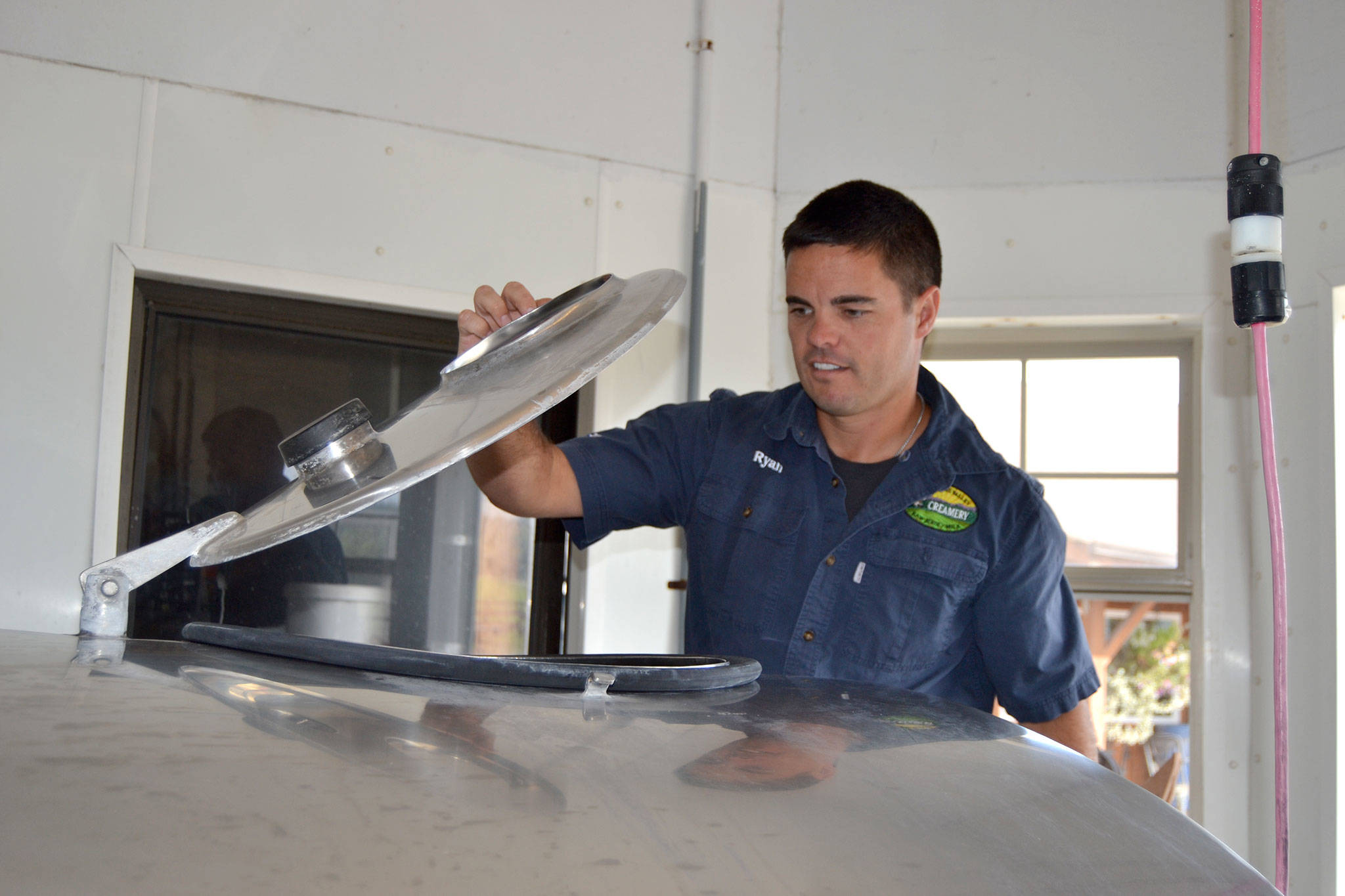 Ryan McCarthey, co-owner of Dungeness Valley Creamery, readies a batch of raw milk for distribution. (Matthew Nash/Olympic Peninsula News Group)