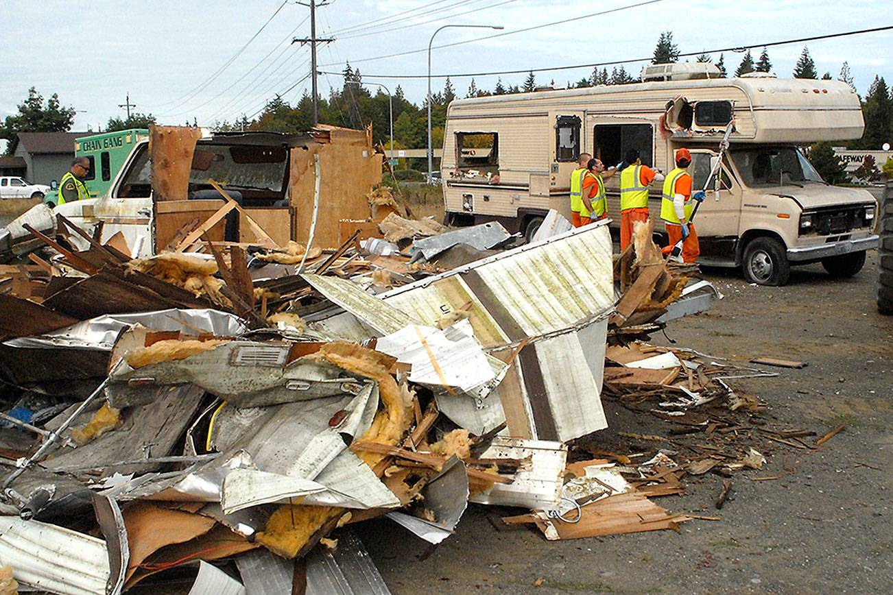 PHOTO: Chain gang dismantles nuisance RVs near Port Angeles