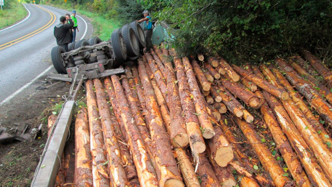 A log truck overturned on state Highway 112 west of Joyce on Friday, closing the road for more than four hours. (Washington State Patrol)