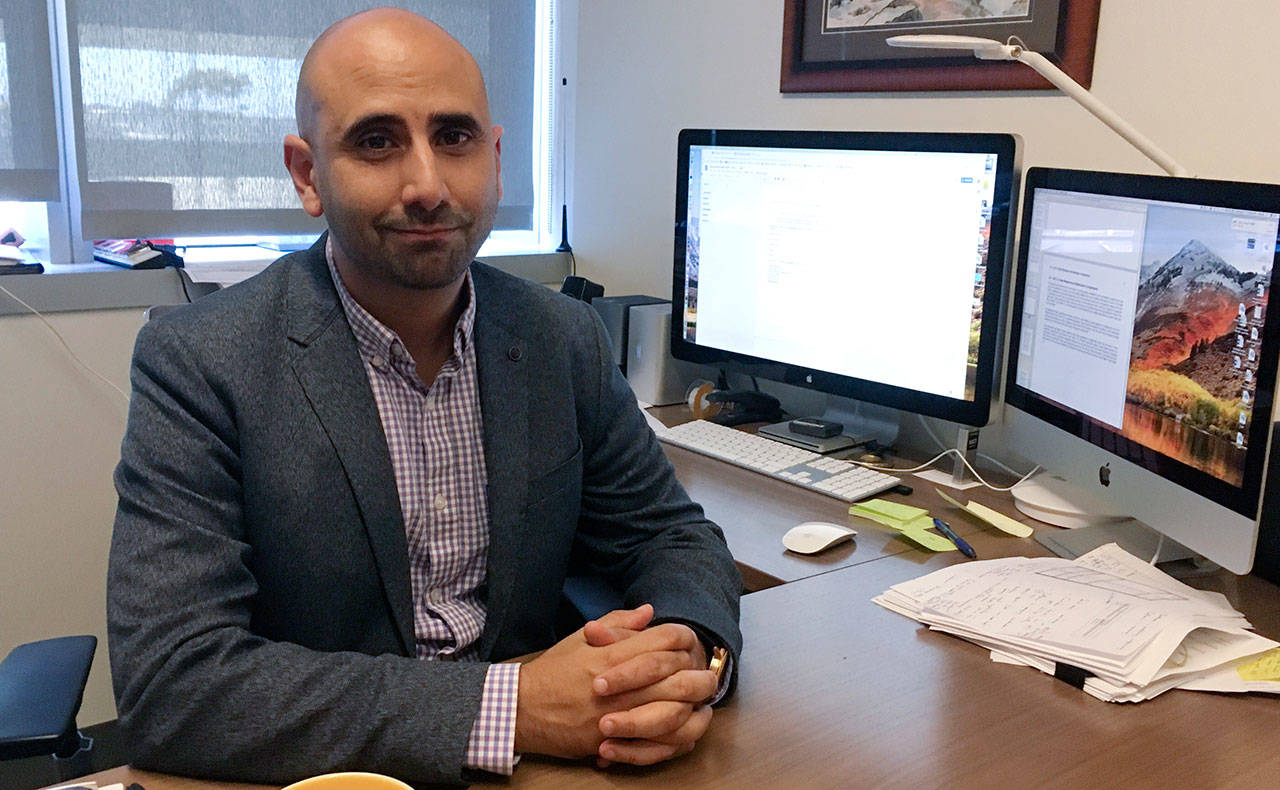 Dr. Fatta Nahab, a neurologist who directs the Functional Imaging of Neurodegenerative Disorders Lab at the University of California San Diego Health’s Movement Disorder Center, sits at his desk Monday in San Diego. Nahab spent years going through regulatory hoops to get approval to import marijuana from Canada, to study whether cannabis can help treat essential tremor, a shaking condition affecting millions of people. (Julie Watson/The Associated Press)