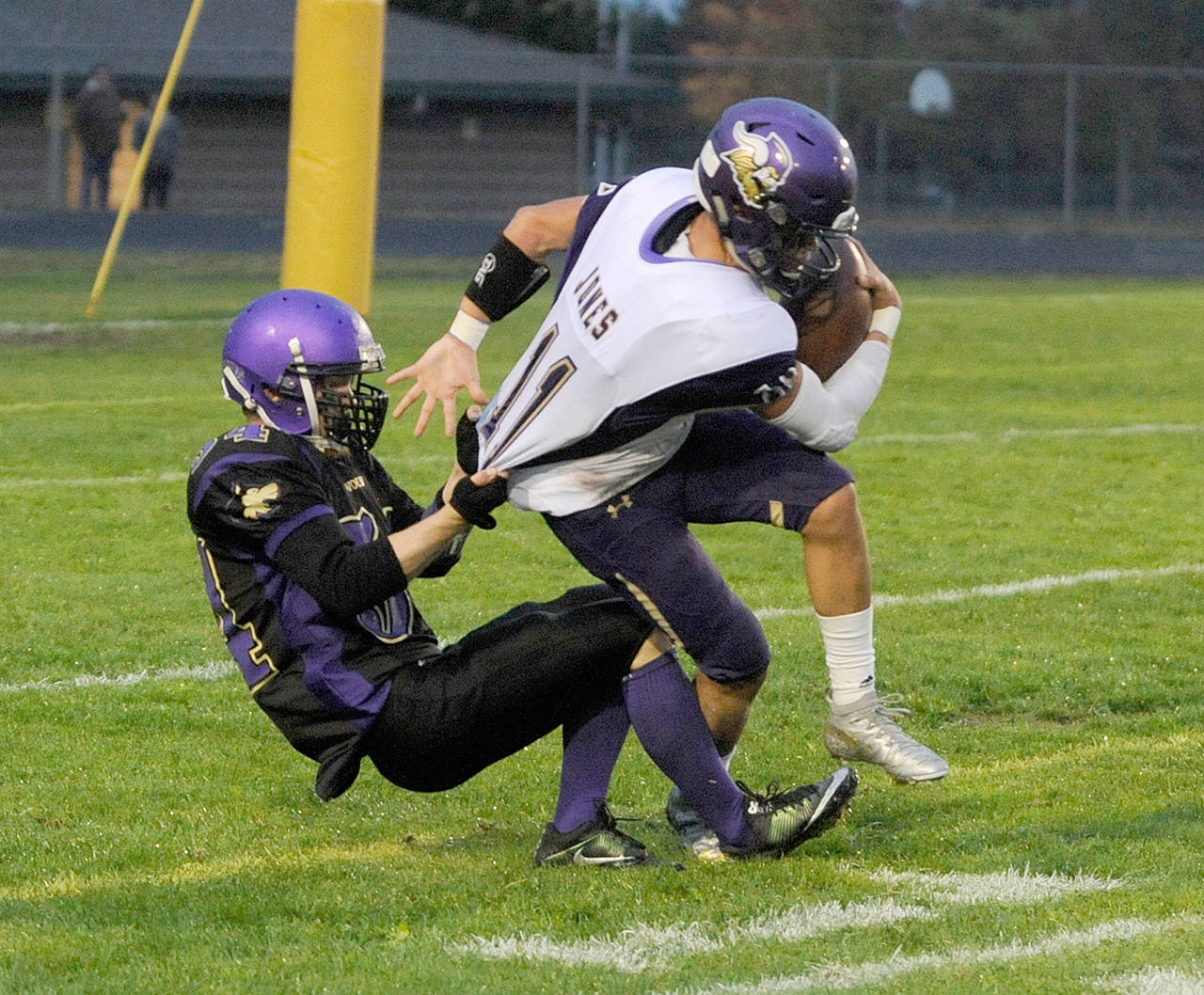 Sequim’s Ben Cowan, left, drags down North Kitsap’s John Jones near the goal line during the Wolves’ 16-14 upset of the Vikings last Friday. Michael Dashiell/Olympic Peninsula News Group