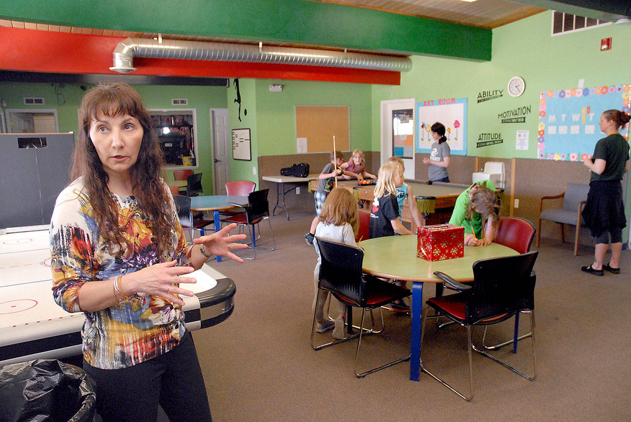 Mary Budke, executive director of the Boys & Girls Clubs of the Olympic Peninsula, stands in the game room of the Mount Angeles Unit in Port Angeles. (Keith Thorpe/Peninsula Daily News)