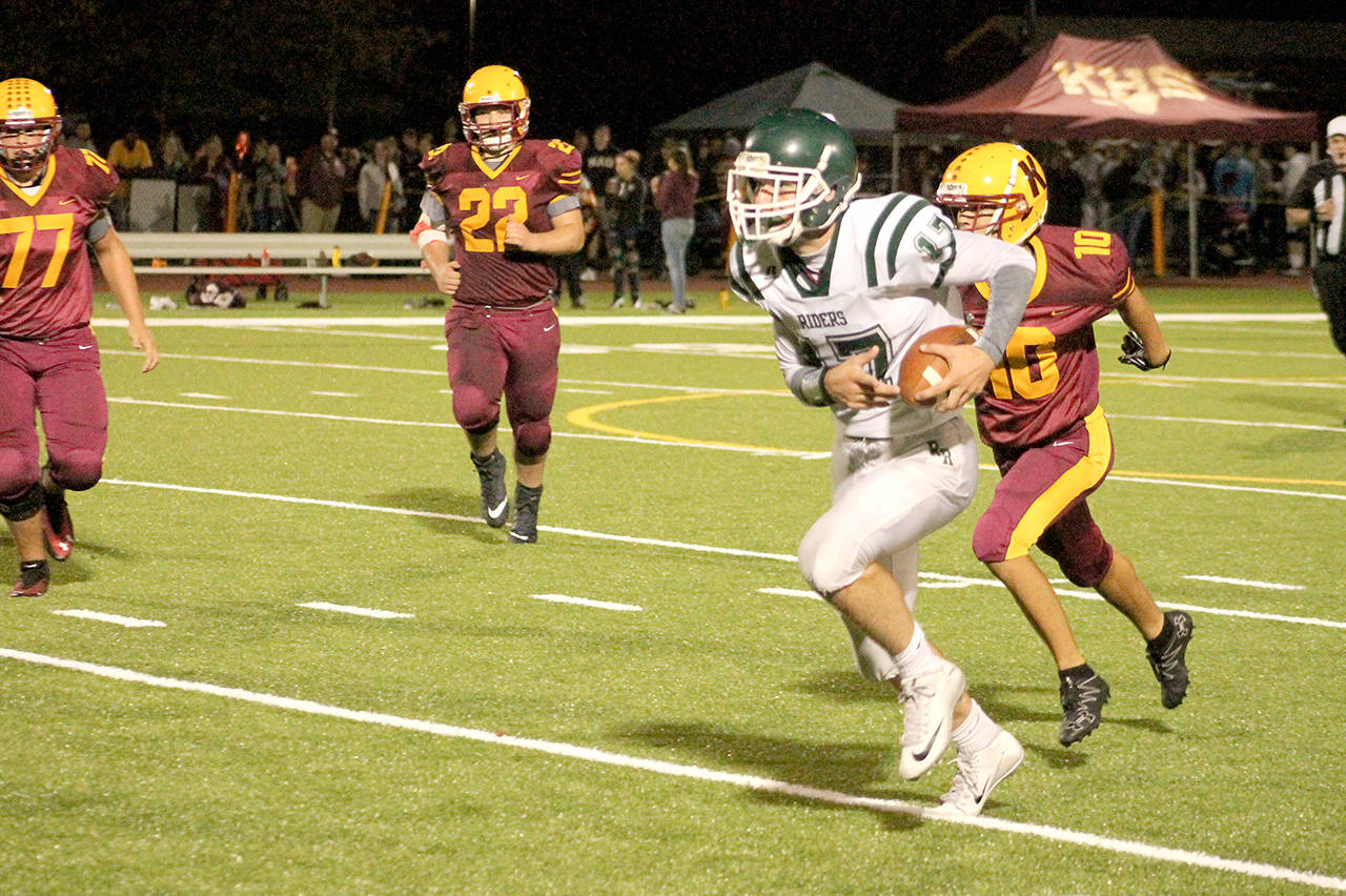 Mark Krulish/Kitsap News Group Port Angeles’ Garrett Edwards runs with the football during the Riders’ 28-6 win over Kingston last week.
