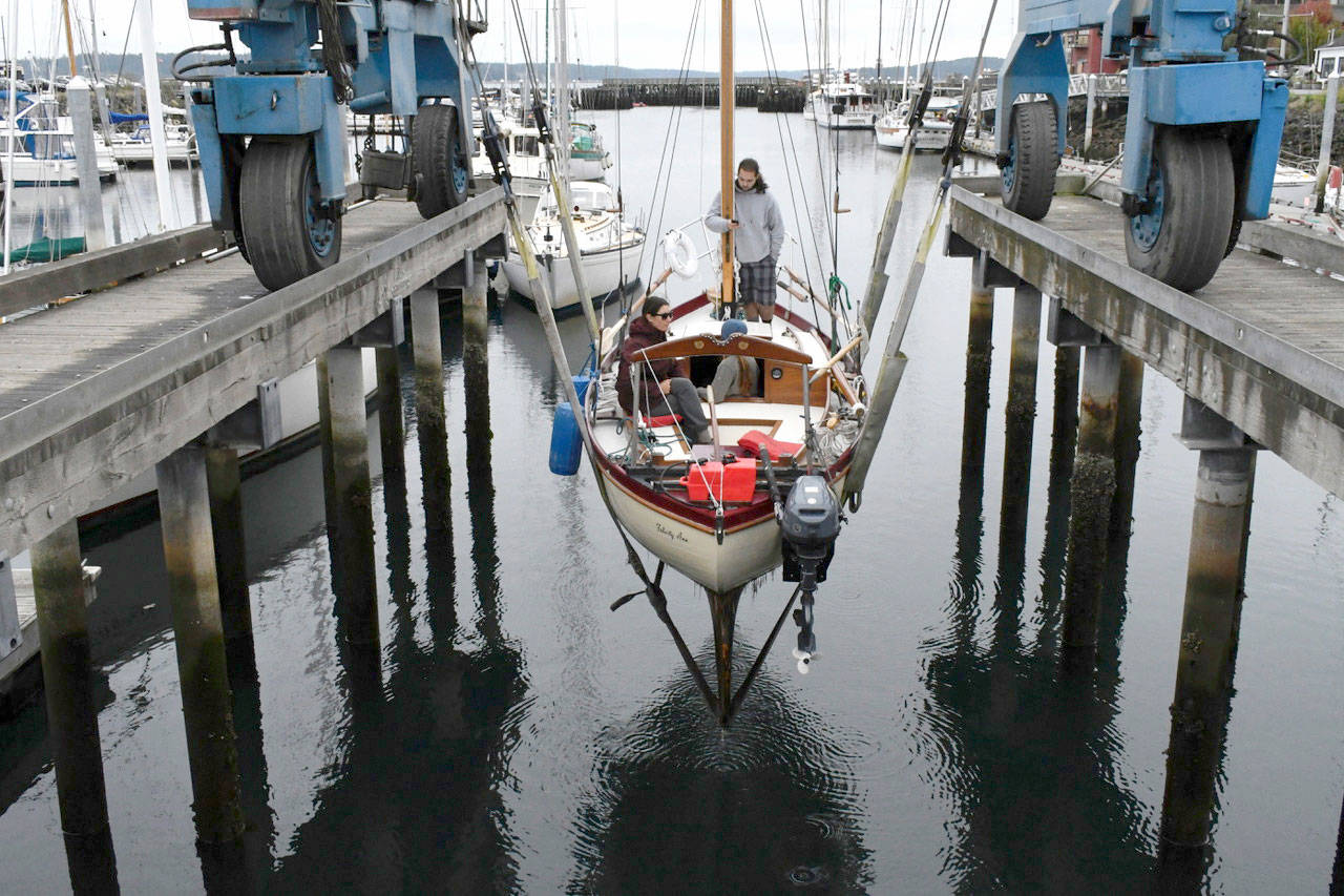 The Felicity Ann and her crew are hoisted out of the water Wednesday after a successful inaugural summer sail and educational tour around Puget Sound, Victoria, B.C. and the San Juan Islands. The historic boat was restored completely by the Northwest School of Wooden Boatbuilding and members of the Community Boat Project, and was launched this summer. (Jeannie McMacken/ Peninsula Daily News)
