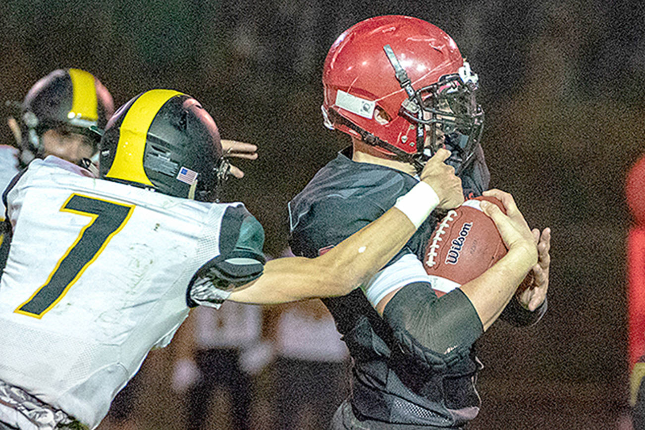 Port Townsend’s Dylan Tracer pulls Vashon defender Sol Dehnert while picking up a first down in a game on Friday at Memorial Field. Steve Mullensky/for Peninsula Daily News