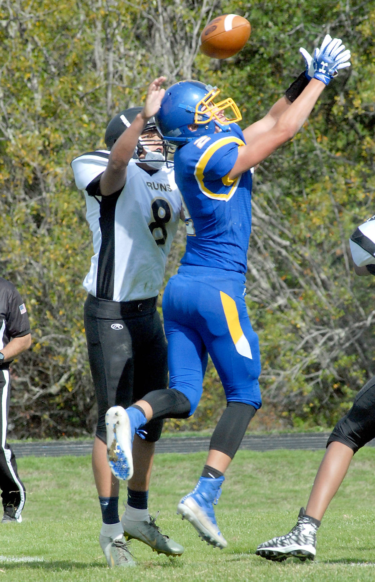 Keith Thorpe/Peninsula Daily News Crescent’s Brenton Dalton, right, and Clallam Bay’s Colin Aldana (No.8) vie to a pass during the first quarter of there Saturday match-up in Joyce.