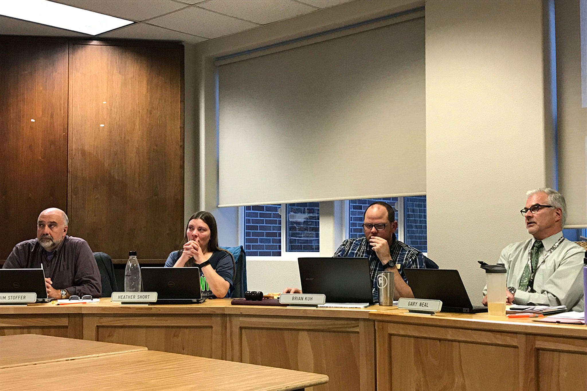 <strong>Erin Hawkins</strong>/Olympic Peninsula News Group Sequim School Board members from left, Jim Stoffer, President Heather Short and vice president Brian Kuh and Superintendent Gary Neal listen as classified staff speak out about contracts at the board meeting Monday.