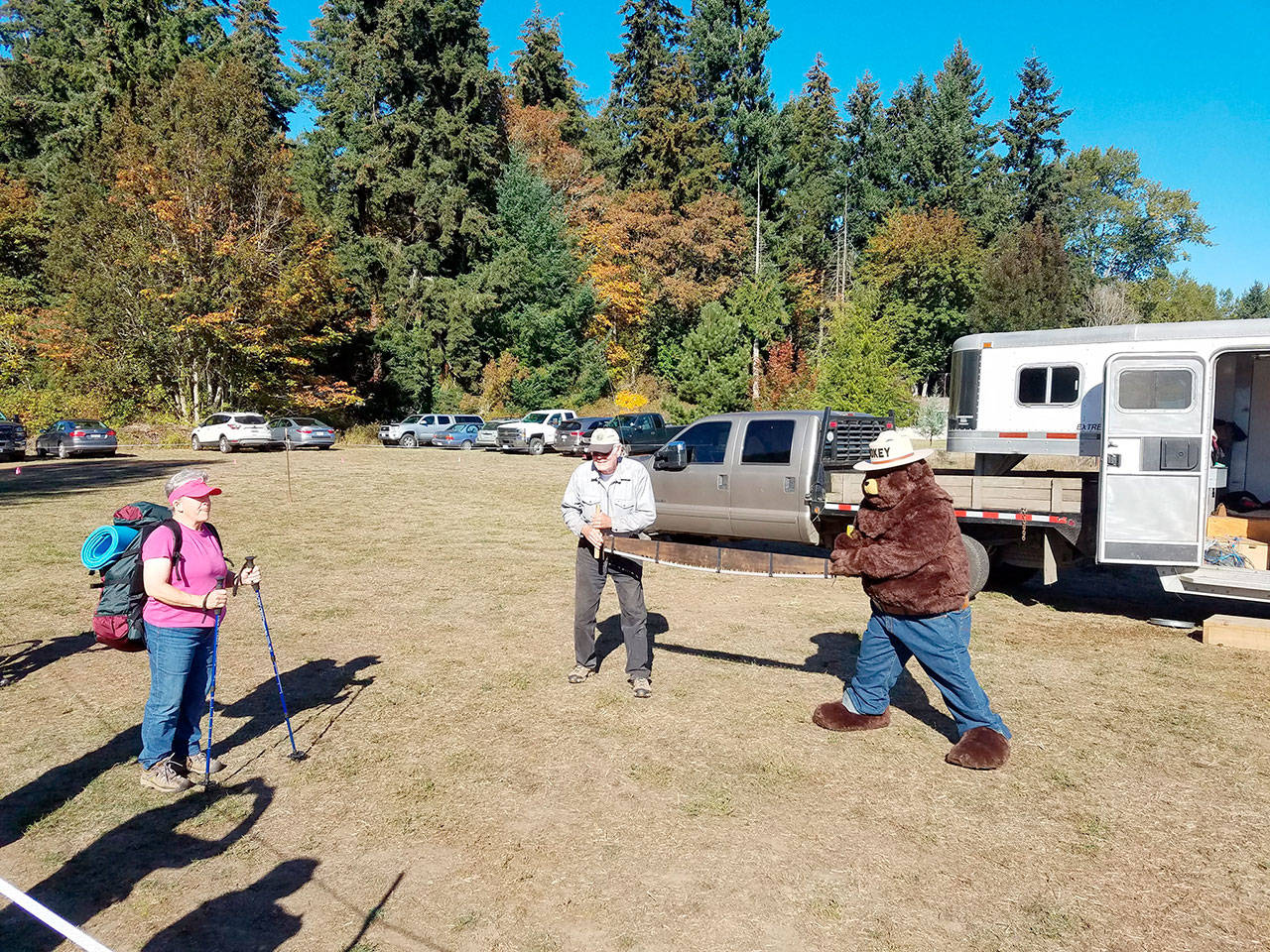 At the Dungeness Railroad Bridge Park’s 20th annual Riverfest, Back Country Horsemen’s Peninsula Chapter was on hand to share wilderness experiences, etiquette and safety issues. Here member Tom Mix and Smokey the Bear explain to hiker Linda Morin the importance of using the Stop, Stand and Speak protocol when backpacking in the mountains. (Rick King)