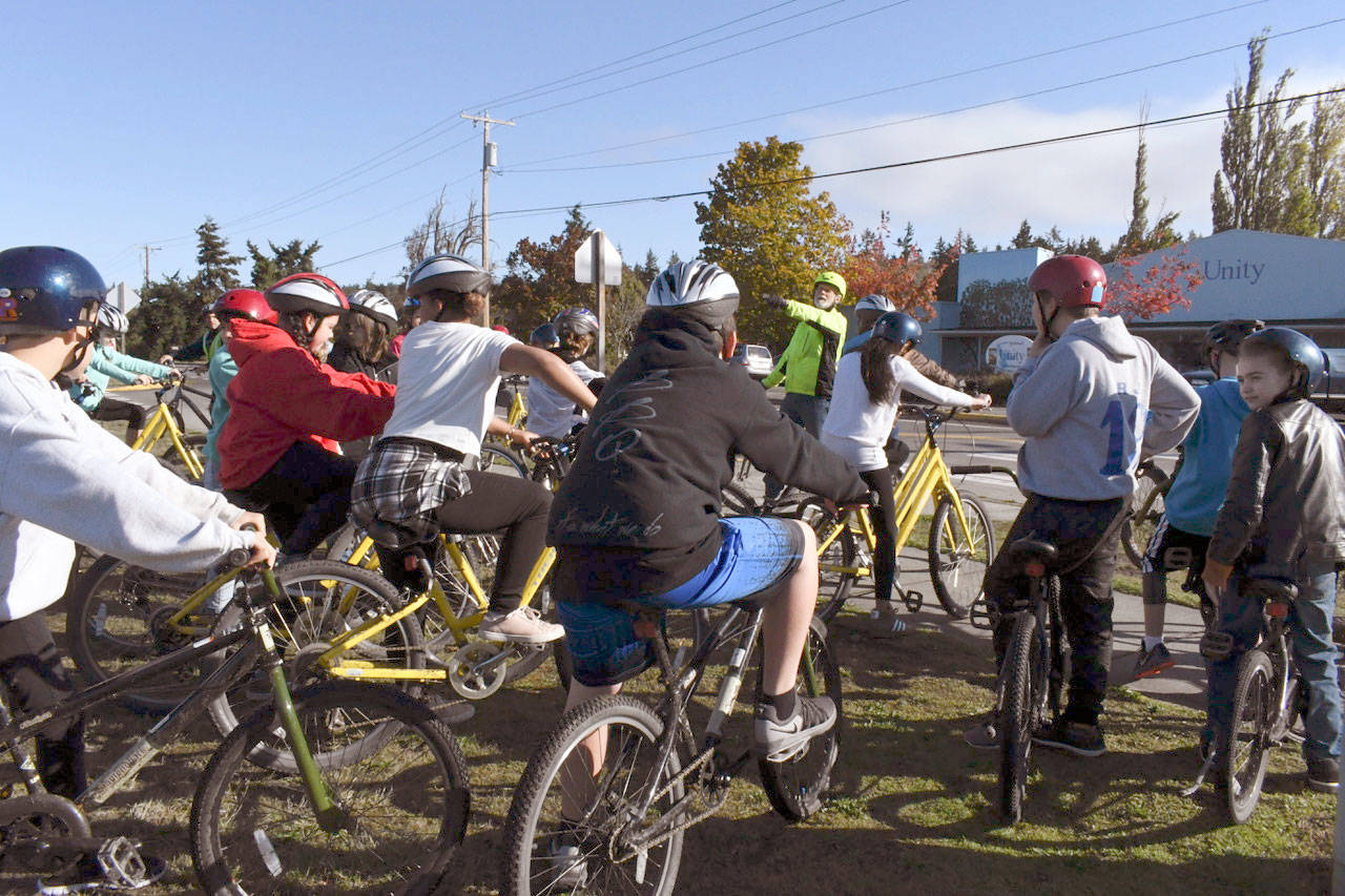 Sixth-grade students at Blue Heron Middle School on Tuesday spent their physical education class learning bicycle safety. Kees Kolff, a volunteer from The ReCyclery and the Port Townsend Cycle School, explains some final rules of the road to the eager riders before biking off on a route of discovery around the local neighborhoods, out to North Beach and to Fort Worden. (Jeannie McMacken/Peninsula Daily News)