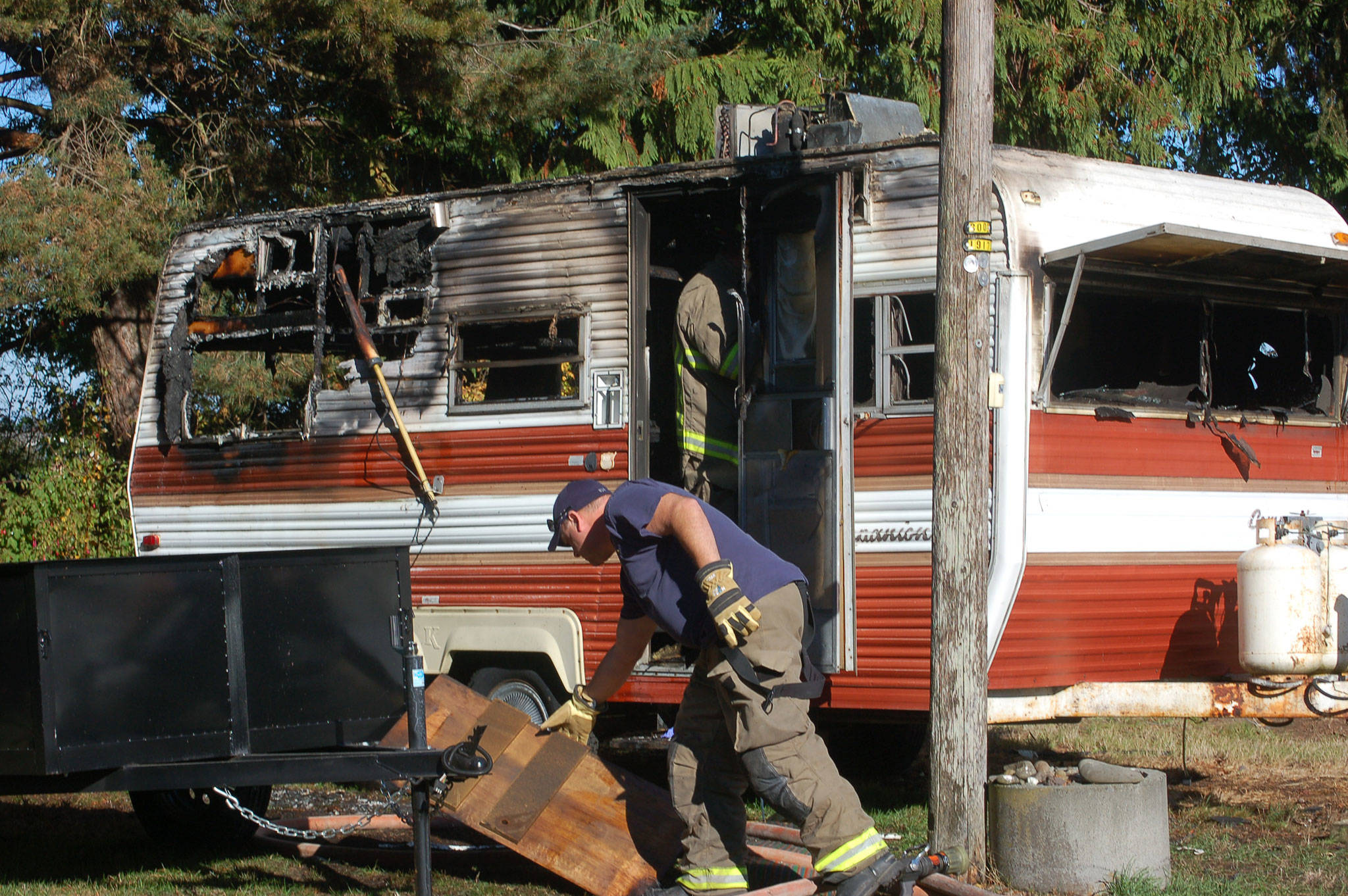 Clallam County Fire District 3 firefighters at the scene of a propane explosion Tuesday afternoon. (Erin Hawkins/Olympic Peninsula News Group)