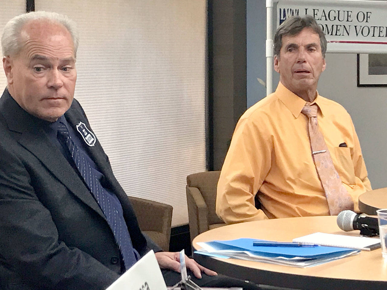 West End-area District Court 2 judge candidates Erik Rohrer, left, and John Black wait Tuesday evening to begin their debate at Peninsula College’s Forks campus while moderator Theresa Tetreau explained the ground rules. (Paul Gottlieb/Peninsula Daily News)
