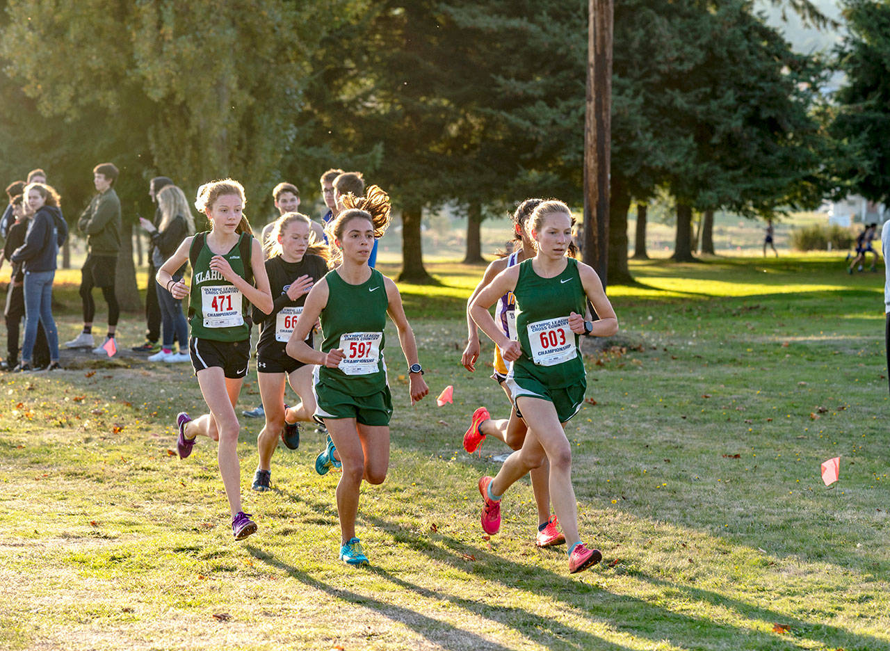 Port Angeles’ Lauren Larson, 603, has a slight edge on teammate Kynzie DeLeon, 597, at Port Townsend Golf Course during the Olympic League Cross Country Championship on Thursday. Larson pulled away and went on to win the girls varsity event while DeLeon came in fourth. Also in the photo is Sequim’s Riley Pyeatt, in black, who finished fifth. (Steve Mullensky/for Peninsula Daily News)