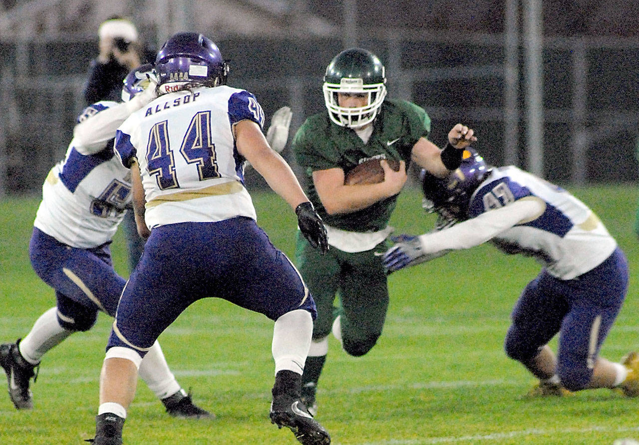 Port Angeles Trevor Shumway, center, is surrounded by the defense of North Kitsap, from left, Kyle Green, Aidan Allsop and Josh Fisher during the second quarter on Friday night at Port Angeles Civic Field. The Roughriders fell 69-0 to North Kitsap. Port Angeles still has a shot at the playoffs and will host North Mason at Civic Field on Friday for Senior Night. (Keith Thorpe/Peninsula Daily News)