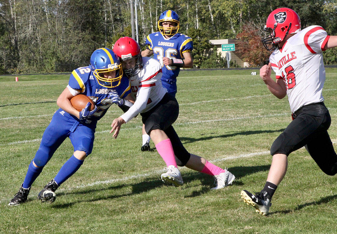 Crescent freshman Wyatt Lee (12) is tackled hard by an Oakville Acorn on Saturday after a handoff from quarterback Eric Emery (36). (Dave Logan/for Peninsula Daily News)