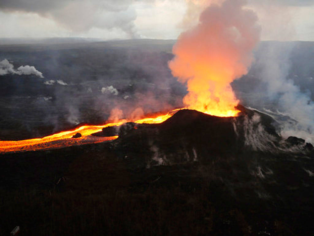 In this July 14 photo provided by the U.S. Geological Survey, lava from the Kilauea volcano erupts in the Leilani Estates neighborhood near Pahoa, Hawaii. (U.S. Geological Survey via AP)