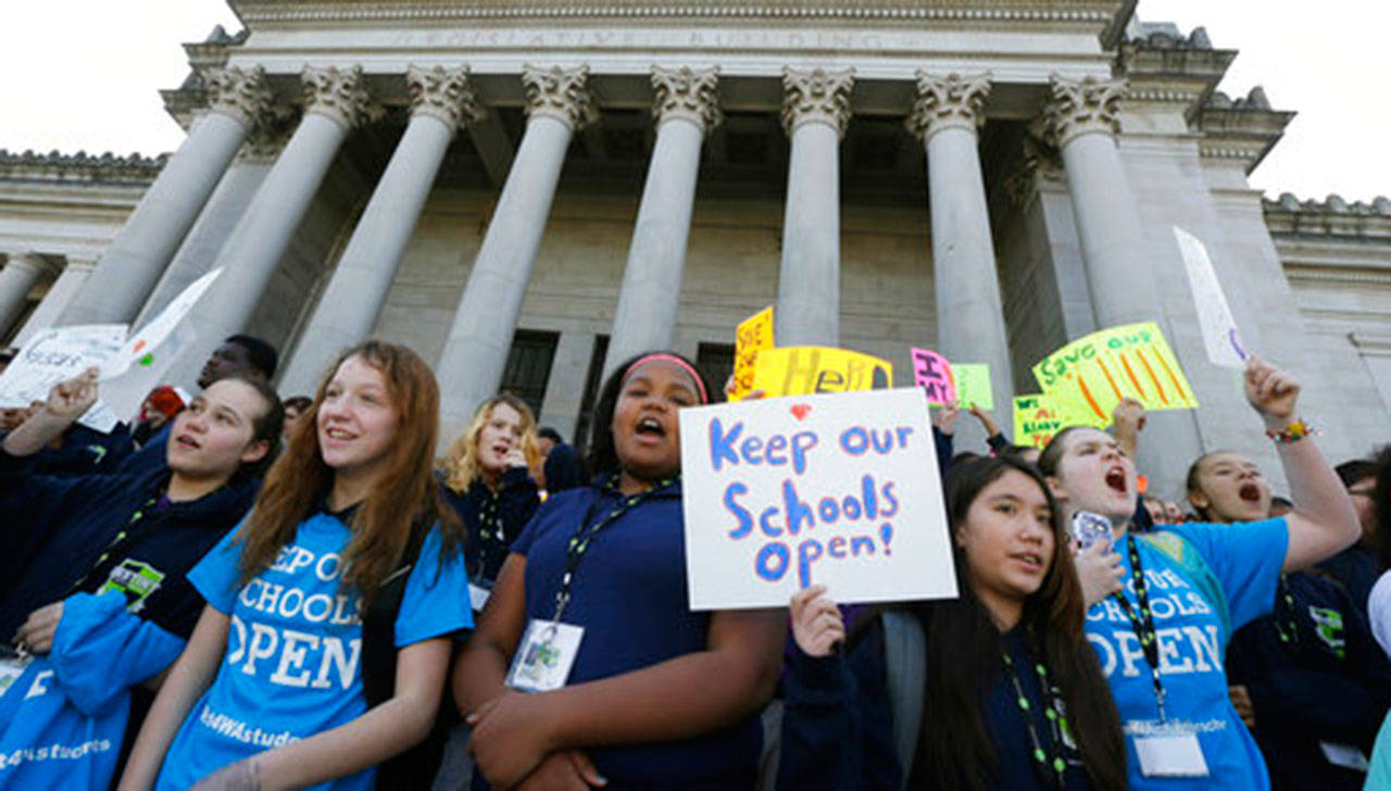 Children hold signs during a rally in support of charter schools at the Capitol in Olympia on Feb. 25, 2016. (Ted S. Warren/The Associated Press)