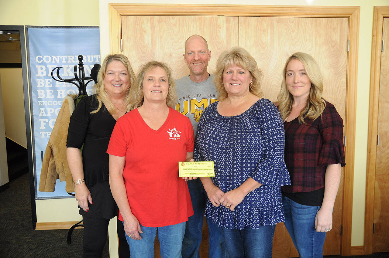 Joining Coats for Kids program representatives are, front row from left, Heidi Albrecht and Karen Lewis and back row from left, Shelley Langston, Learning Support Services executive director; Sequim School District psychologist Matt Duchow, and Special Programs coordinator Renee Alcafaras. (Michael Dashiell /Olympic Peninsula News Group)