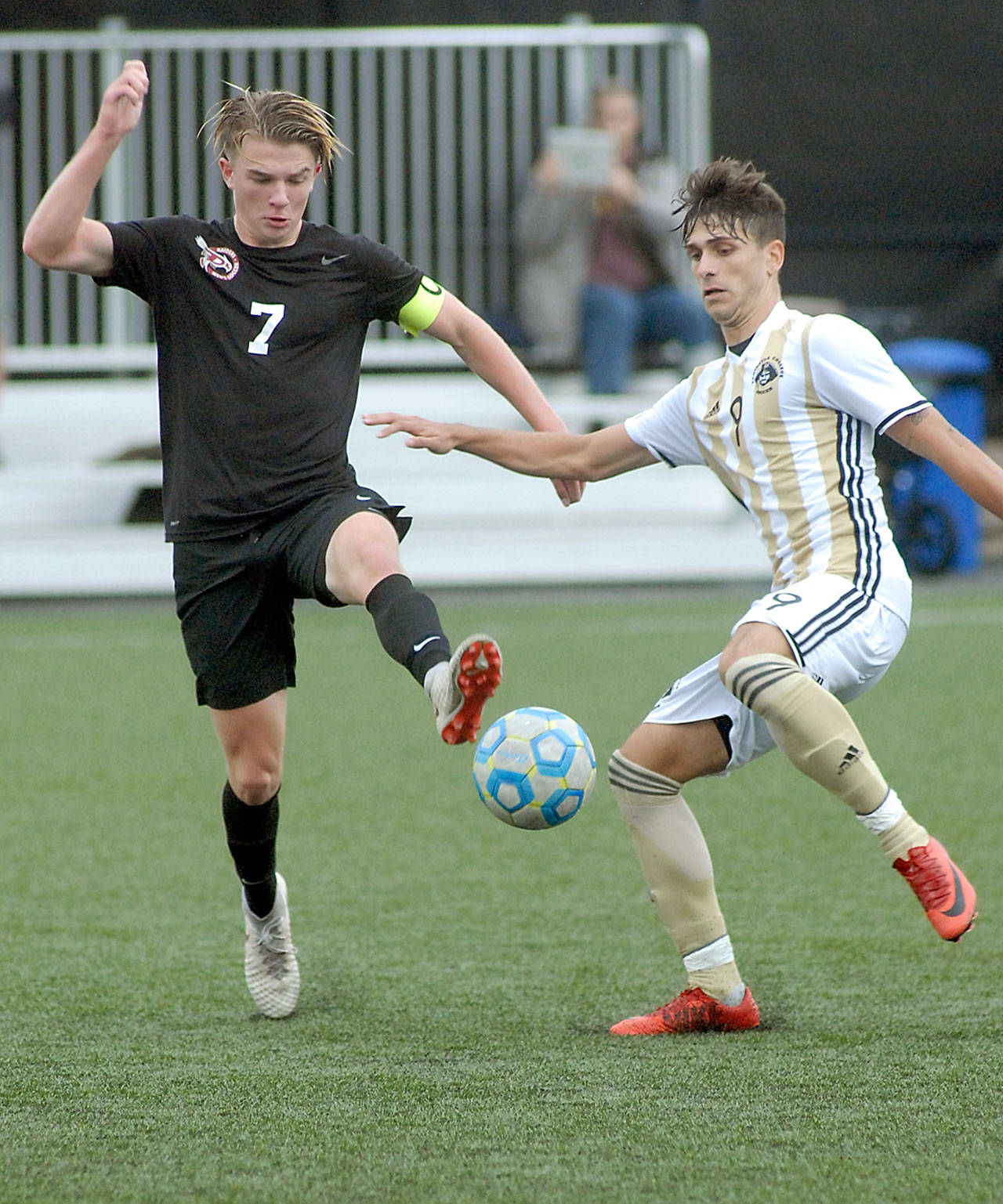 Pierce’s Austin Stafford, left, and Peninsula’s Manuyel Galiano dance around a loose ball during Wednesday’s NWAC first-round playoff game at Wally Sigmar Field in Port Angeles. Keith Thorpe/Peninsula Daily News