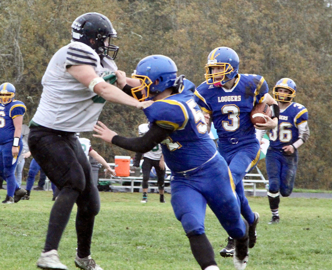 Crescent Logger No. 3 Malachi Treadway, a freshman, gets a block from his teammate Noah Leonard (54) as he runs around his left end. Eric Emery 36) is in the background. (David Logan/for Peninsula Daily News)