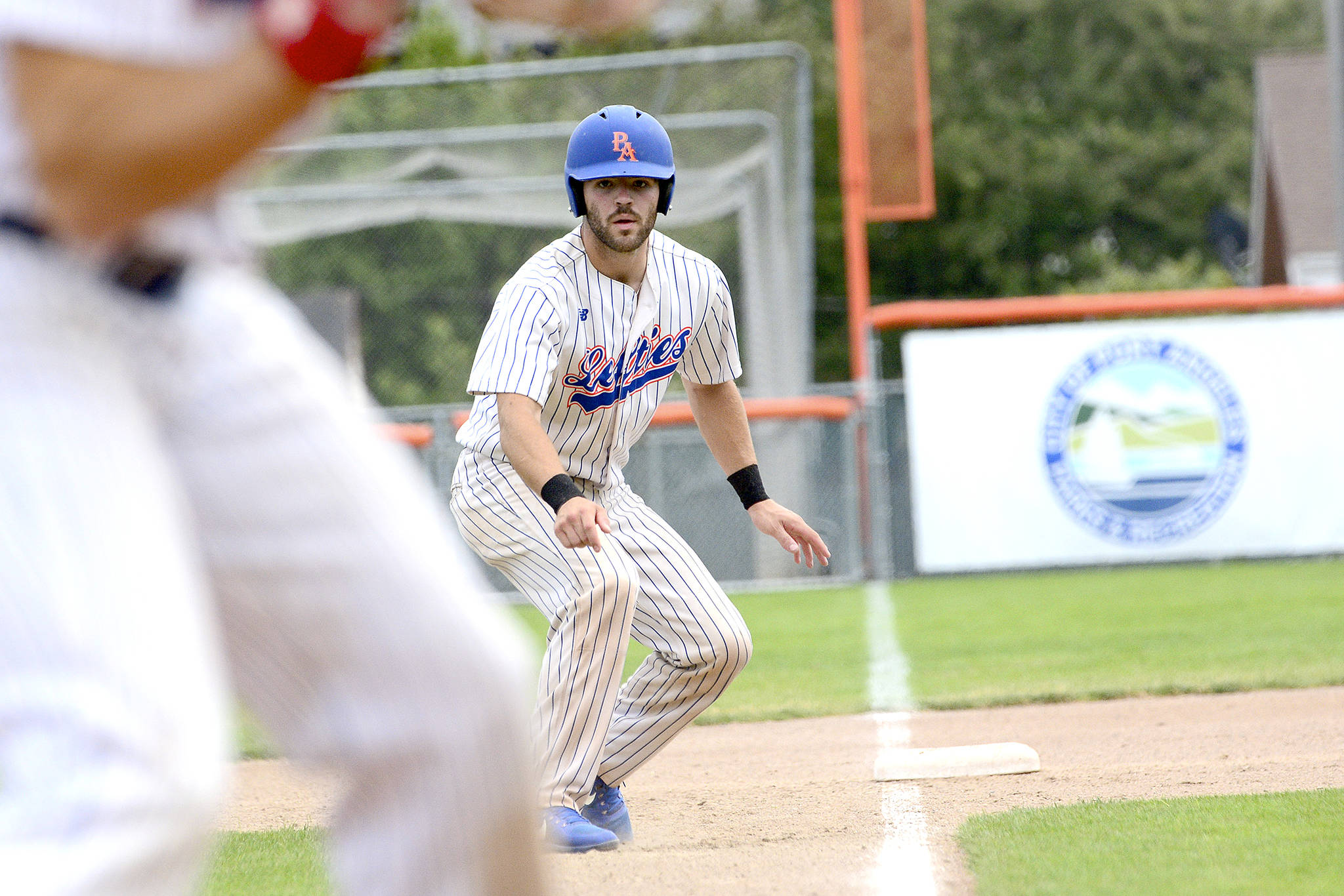 &lt;strong&gt;Jesse Major&lt;/strong&gt;/Peninsula Daily News                                Port Angeles Lefties catcher Ronnie Rust eyes home plate before scoring in the second inning against the Yakima Valley Pippins during a game in July. Rust is returning to the Lefties next season.