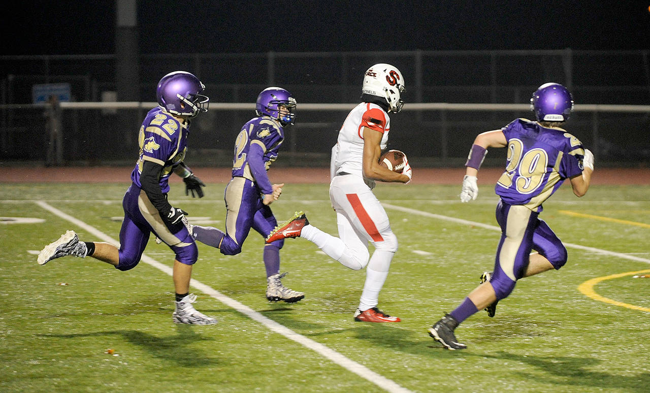 Michael Dashiell/Olympic Peninsula News Group Steilacoom sophomore receiver Emeka Egbuka (2) races through the Sequim defense for oneof his three first-half touchdown receptions in the Wolves’ 49-12 loss Friday. From left, Sequim’s Walker Ward Kyler Rollness and Joey Oliver give chase.