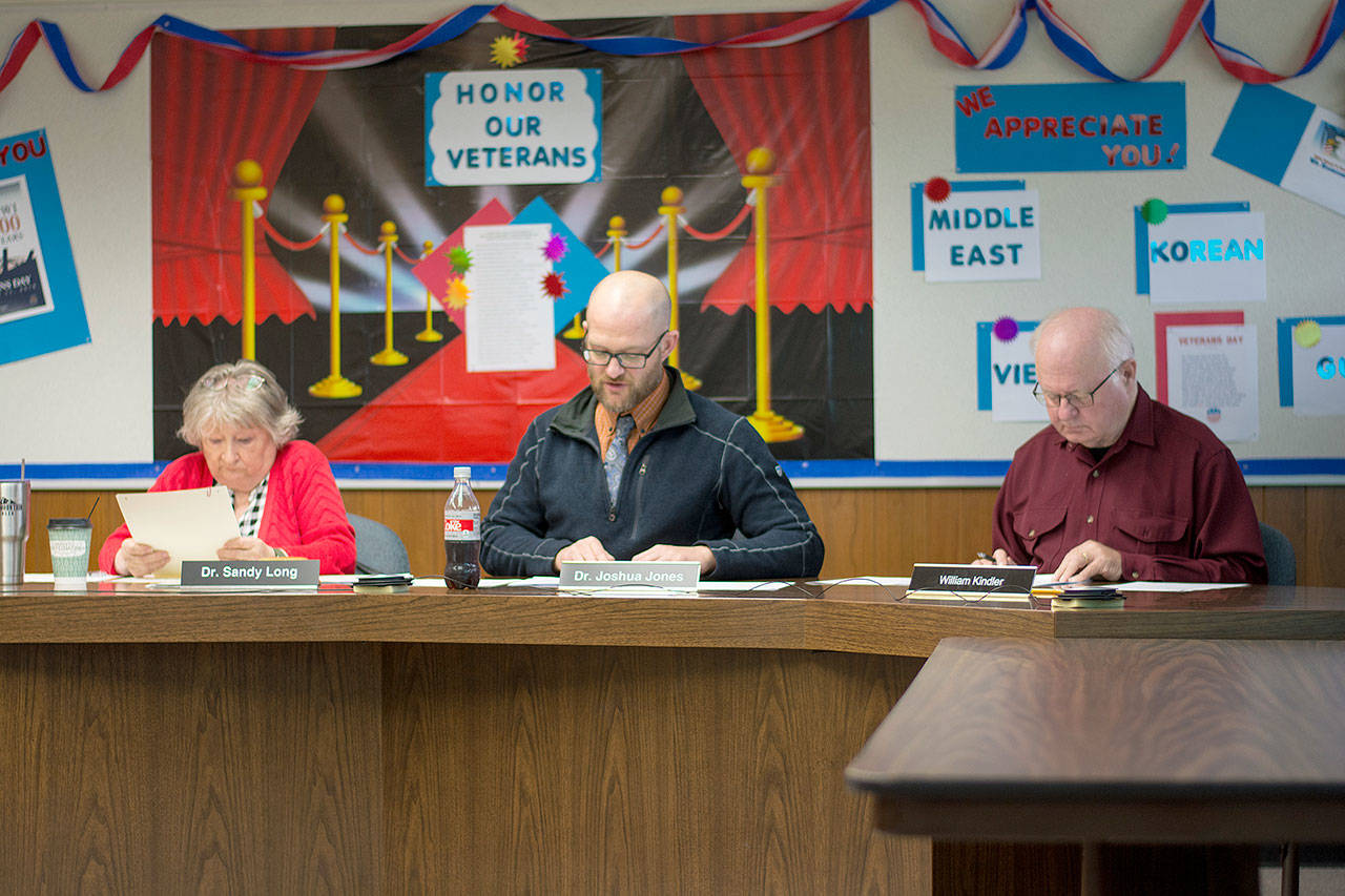 Port Angeles School District School Board Directors Sandy Long, Josh Jones, middle, and William Kindler approved four resolutions addressing the paraeducators’ strike without discussion. Directors Sarah Methner and Cindy Kelly phoned in for the special meeting Wednesday. (Jesse Major/Peninsula Daily News)