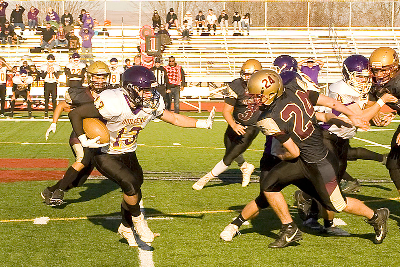Patrick Shelby/Daily Sun News                                Quilcene senior Olin Reynolds (13) prepares to stiffarm a Sunnyside Christian defender during the Rangers’ 54-50 state quarterfinal win last Saturday.