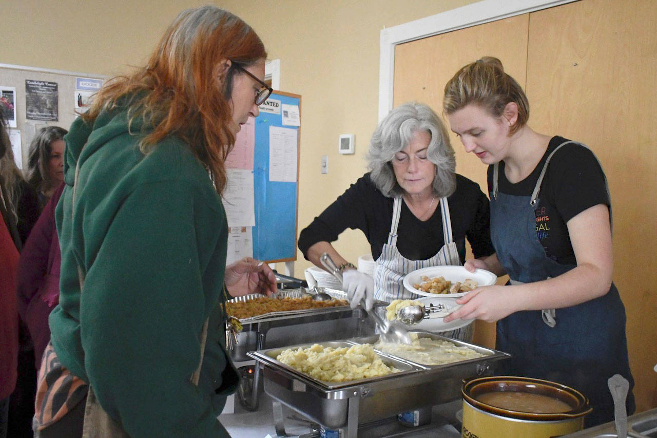 St. Paul’s Episcopal Church in Port Townsend served a record number of meals Wednesday as part of its Just Soup program. Volunteers Erica Bauermeister, left, and Anna Wilke served up a full Thanksgiving feast prepared by members of the congregation. (Jeannie McMacken/Peninsula Daily News)