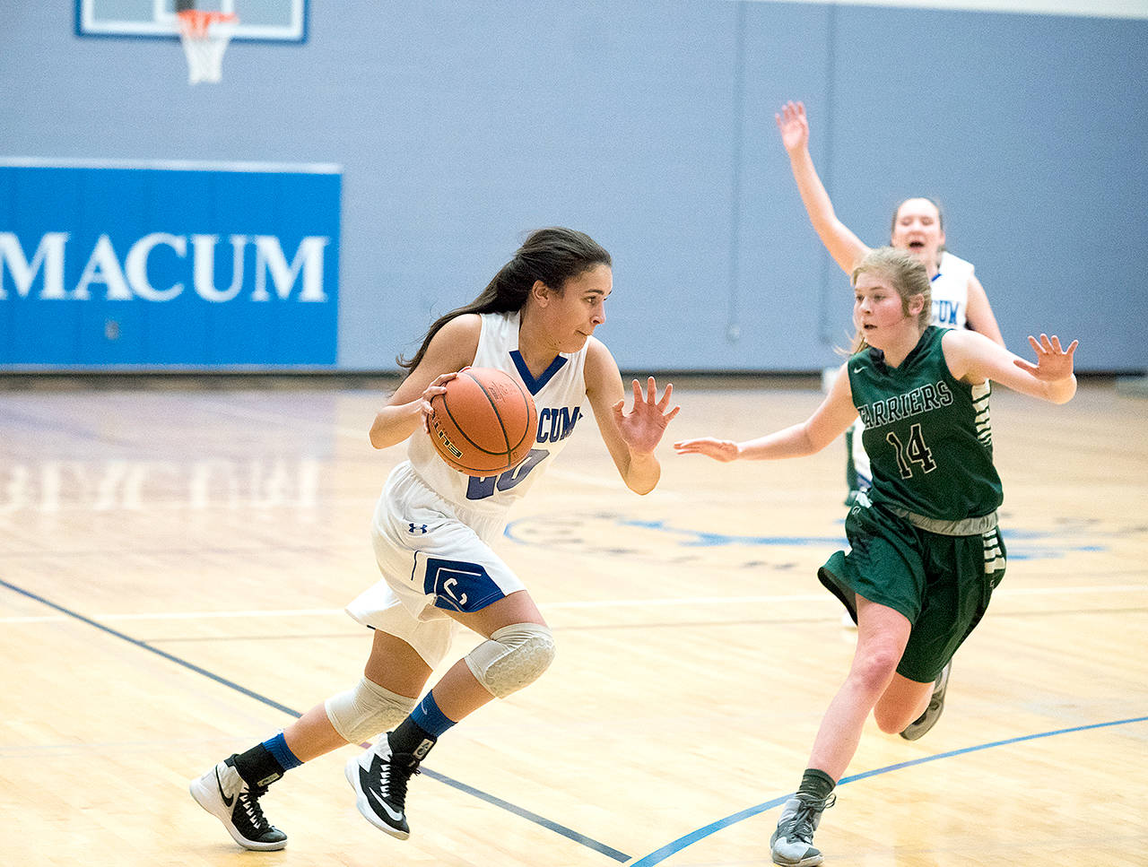 Steve Mullensky/for Peninsula Daily News Chimacumâs Mia McNair, left, drives while defended by Charles Wrightâs Grace Hanley during a district playoff game last season.
