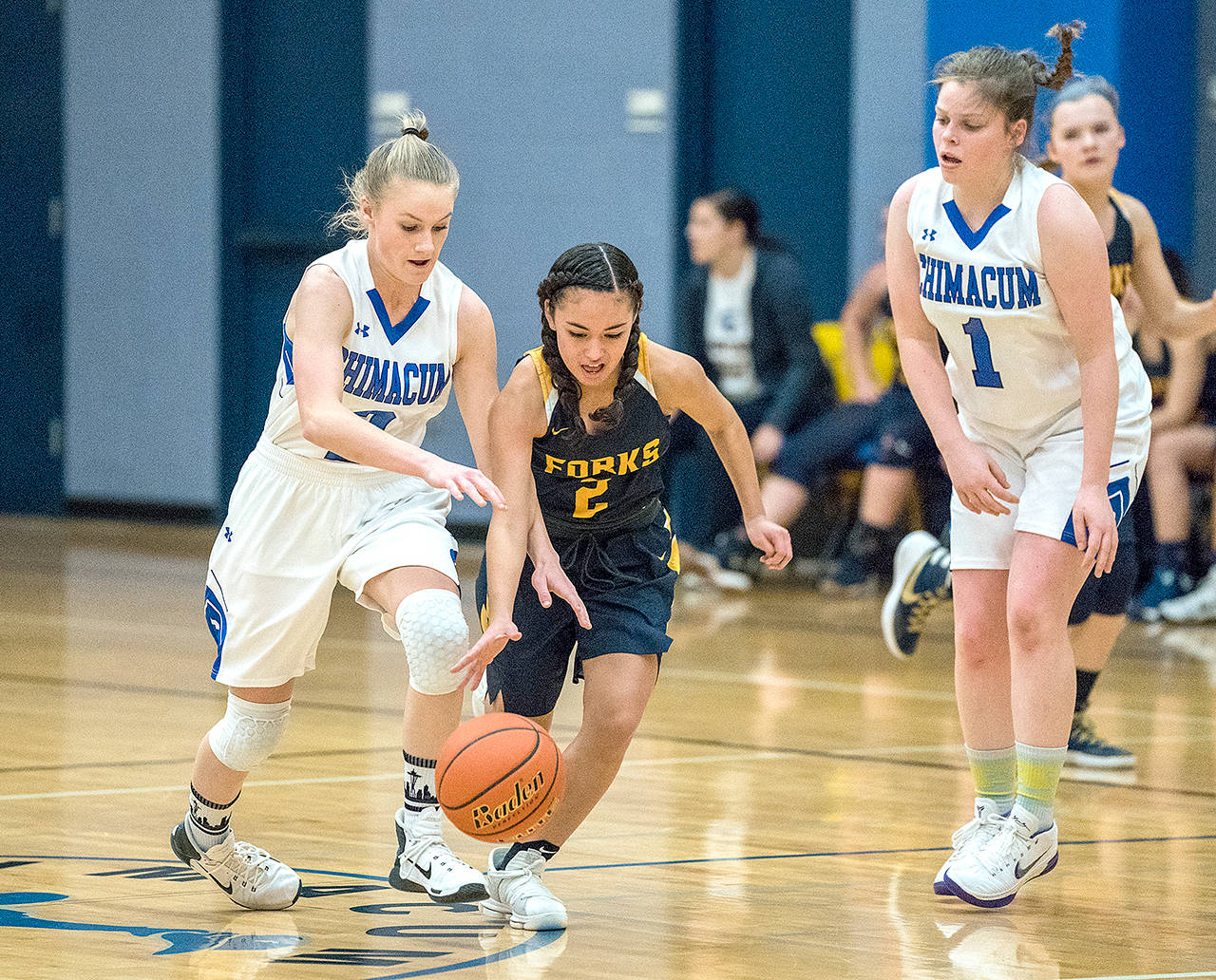 Steve Mullensky/for Peninsula Daily News Forks’ Iesha Johnson, center, vies for control of the ball during a 2017 game against Chimacum.