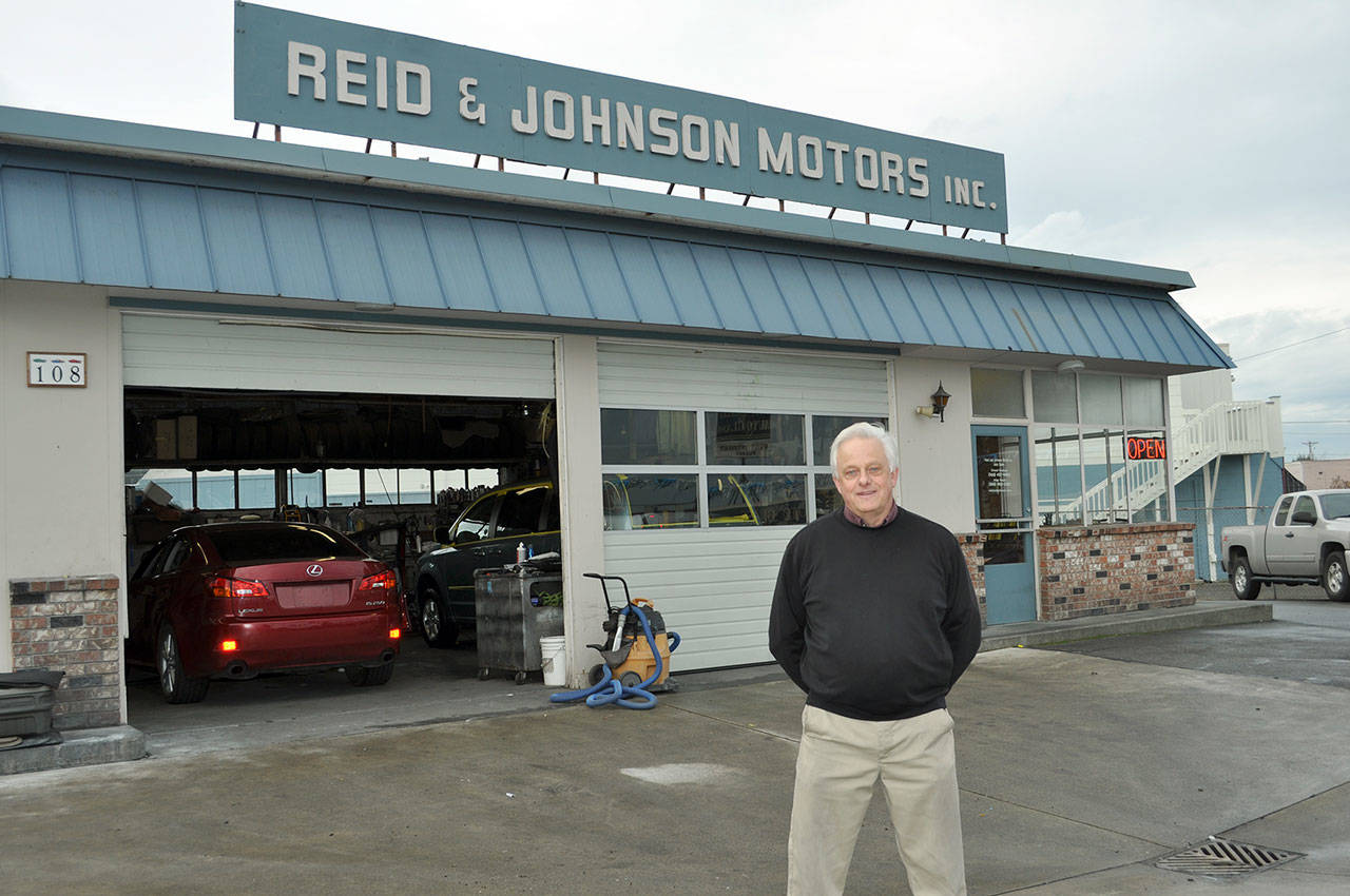 Bob Reid stands in front of Reid and Johnson Motors in Port Angeles, which is celebrating its 50th anniversary. (Vivian Hansen/Peninsula Daily News)
