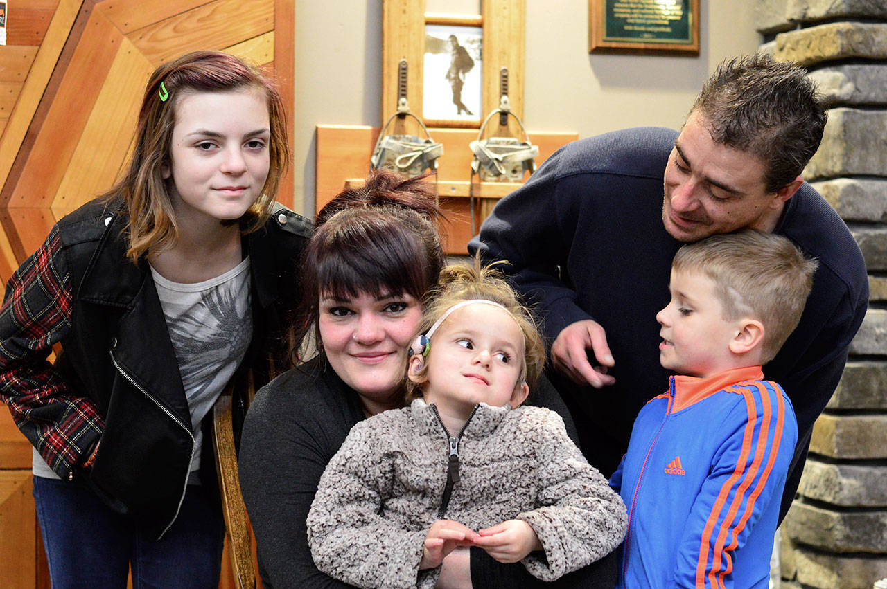 (Diane Urbani de la Paz/for Peninsula Daily News) Nina Jones, center, pauses with daughter Sarah, 4, on her lap and Samee, 13, at left, with son Nick, aka Bear, 5, and dad Nick Landvik on her right.