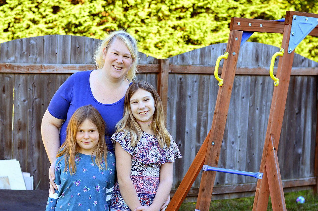 Alexis Haire lives in the Port Angeles home she built for herself and her daughters Maddie, 7, left, and Lily, 11. (Diane Urbani de la Paz/for Peninsula Daily News)