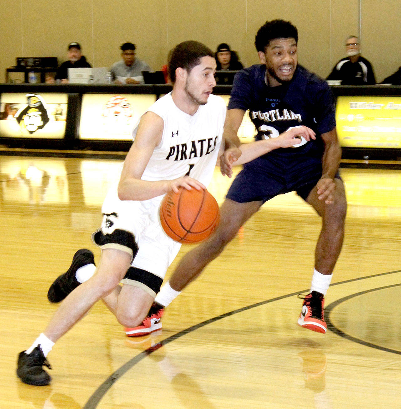 Peninsula’s James Buckley drives around a Portland player in the Pirates’ xxx win Sunday in Port Angeles. (Dave Logan/for {Peninsula Daily News)