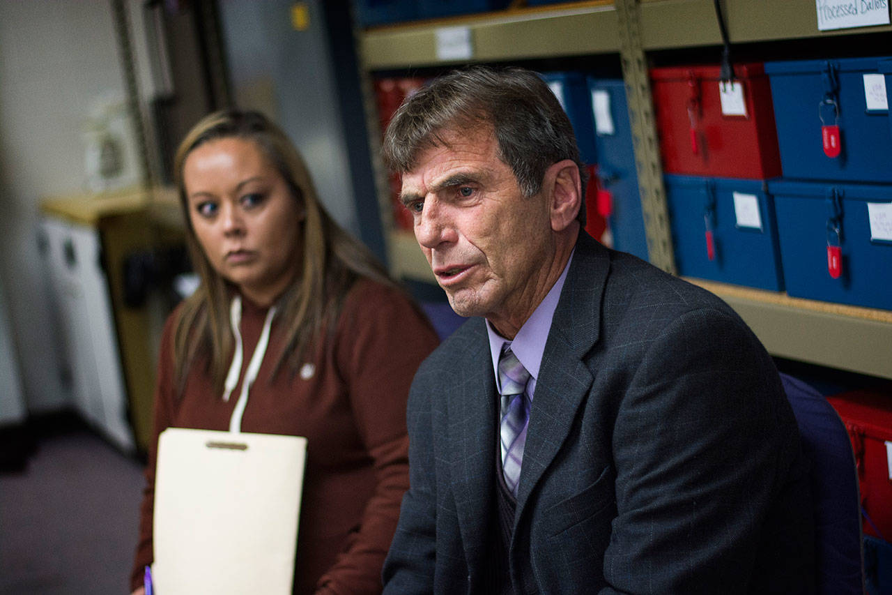 John Black, the candidate who requested a recount in the race for the District Court II judge seat, addresses the Clallam County Canvassing Board on Monday. (Jesse Major/Peninsula Daily News)