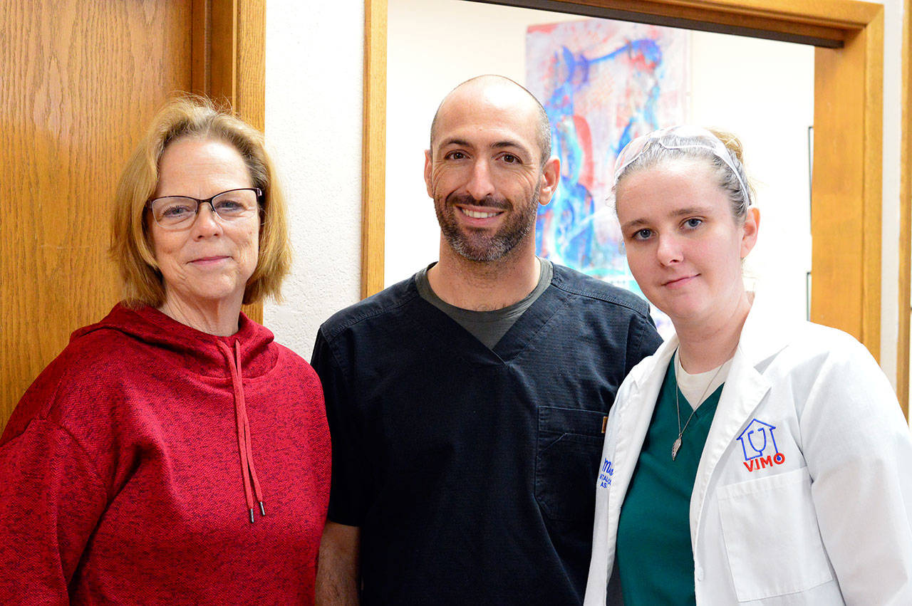 VIMO Executive Director Mary Hogan, left, works with volunteer Dr. Joe Churchill and Dental Clinic Manager Mischa Levis. (Diane Urbani de la Paz/for Peninsula Daily News)
