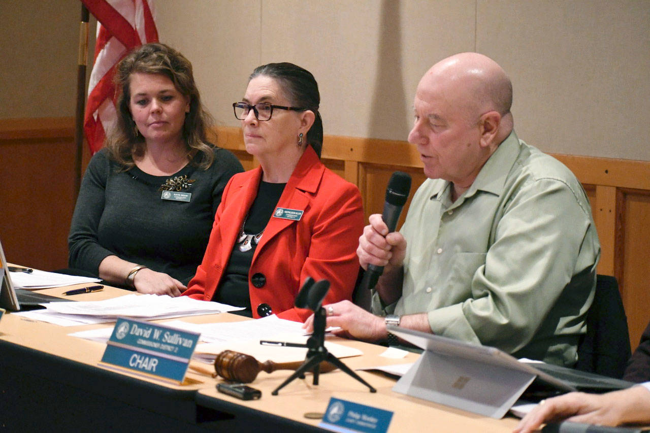 Jefferson County Commissioners voted Friday to pass a harmonizing ordinance, ending the year-long debate on commercial shooting facilities in the county. Chair David Sullivan called the question as Commissioner Kate Dean, left, and Commissioner Kathleen Kler prepare to announce their vote. The ordinance passed 2-1 with Dean voting nay. (Jeannie McMacken/Peninsula Daily News)