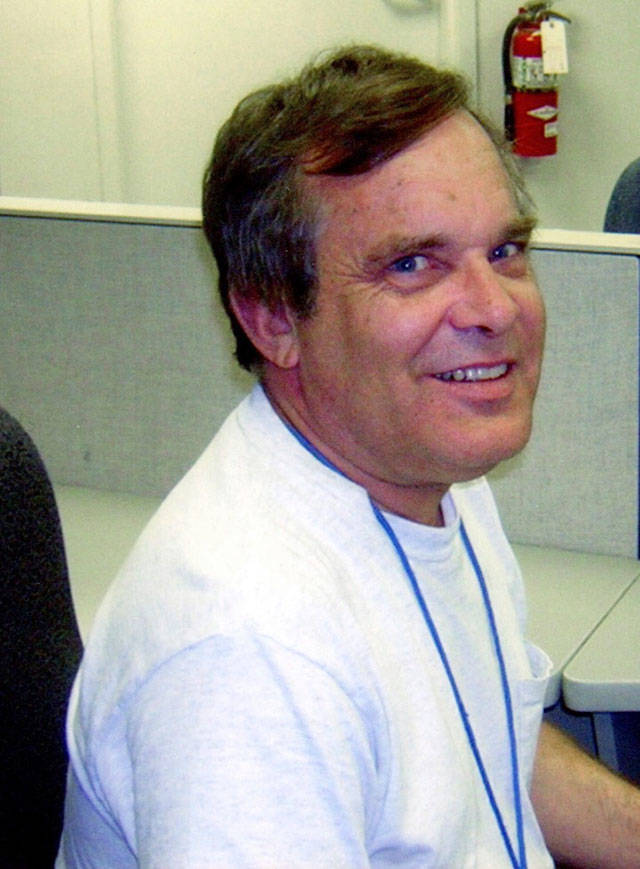 In this 2013 photo provided by Susan E. Madsen, Alan Naiman poses for a photo at his work at Children’s Administration (DSHS) Child Protective Services in Seattle. (Susan E. Madsen via AP)