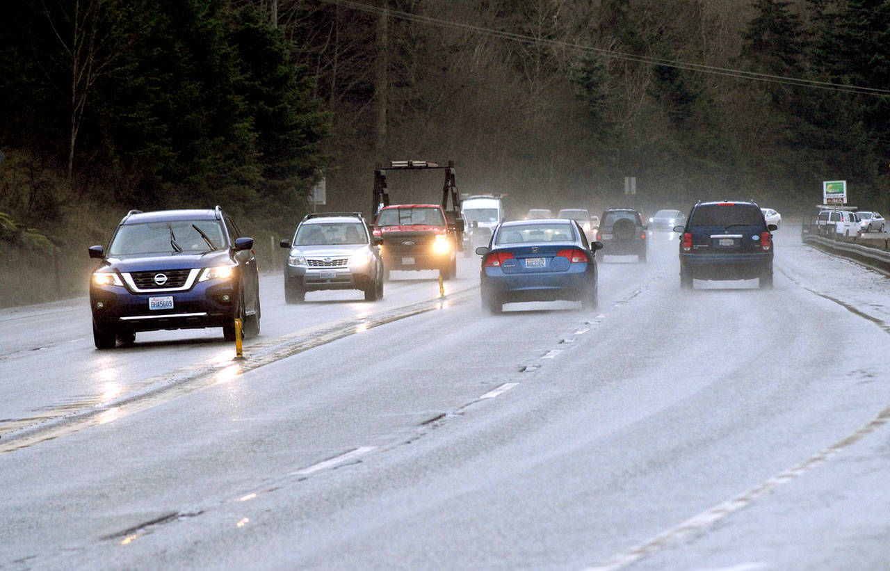 Traffic makes its way on U.S. Highway 101 near Morse Creek east of Port Angeles on Tuesday. Vehicles traveling at highway speeds are currently separated by only center line markers and a rumble strip. (Keith Thorpe/Peninsula Daily News)