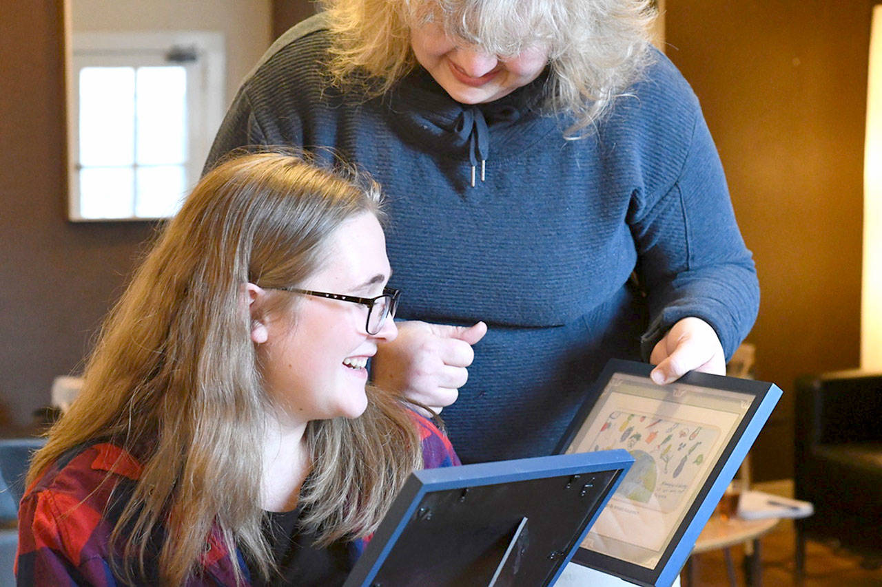 Marie Youssefirad surprised Amelia Rose Kauzlarich, 14, with a certificate and flowers for her winning design in the Type 2 Diabetes License Plate Design competition. Kauzlarich will also be awarded $200 this summer by the Fariborz Youssefirad Memorial Health Scholarship. (Jeannie McMacken/Peninsula Daily News)