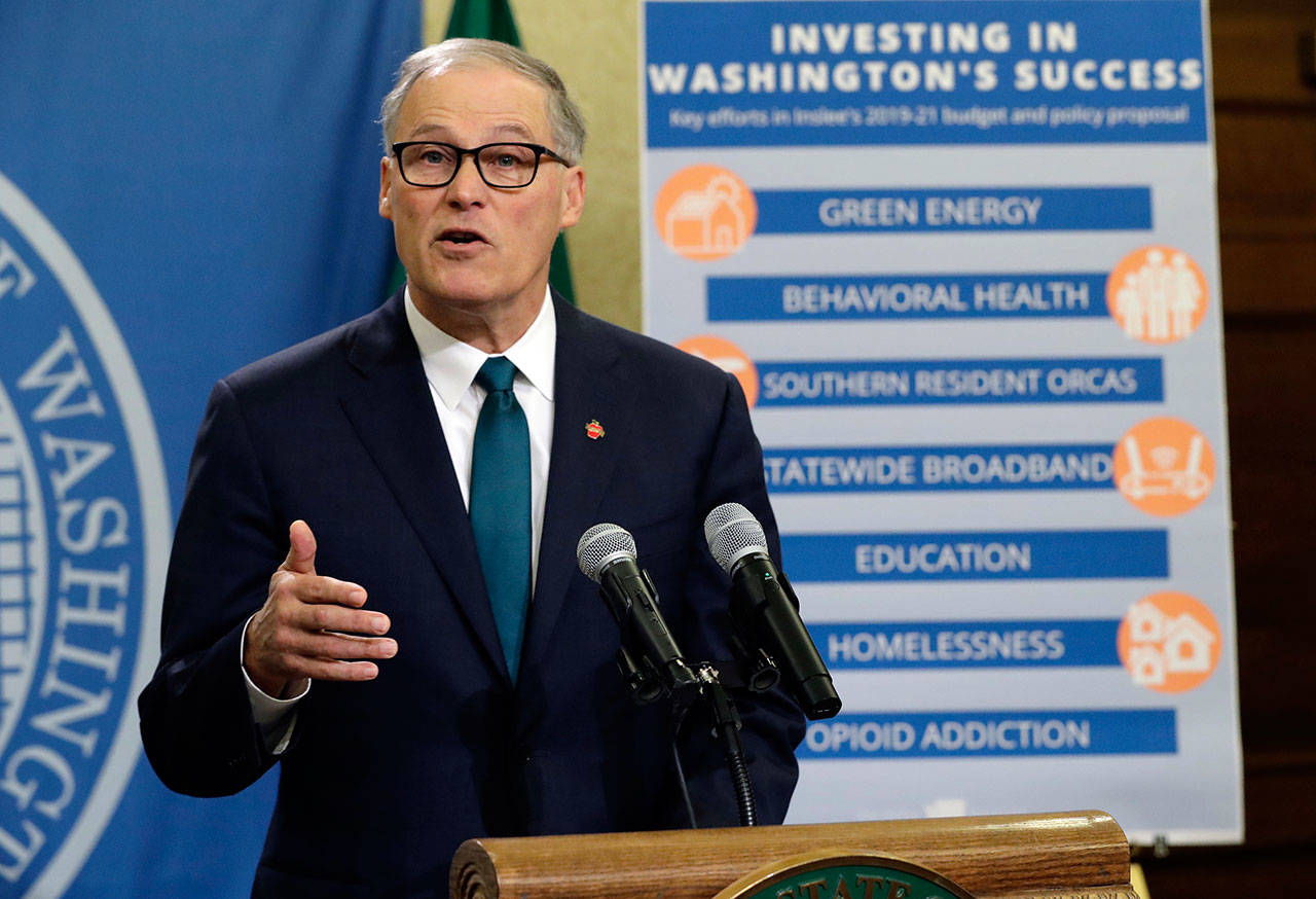 Gov. Jay Inslee’s proposal of a $54.4 billion state budget would include a capital gains tax expected to raise $975 million in revenue in 2021. (The Associated Press)