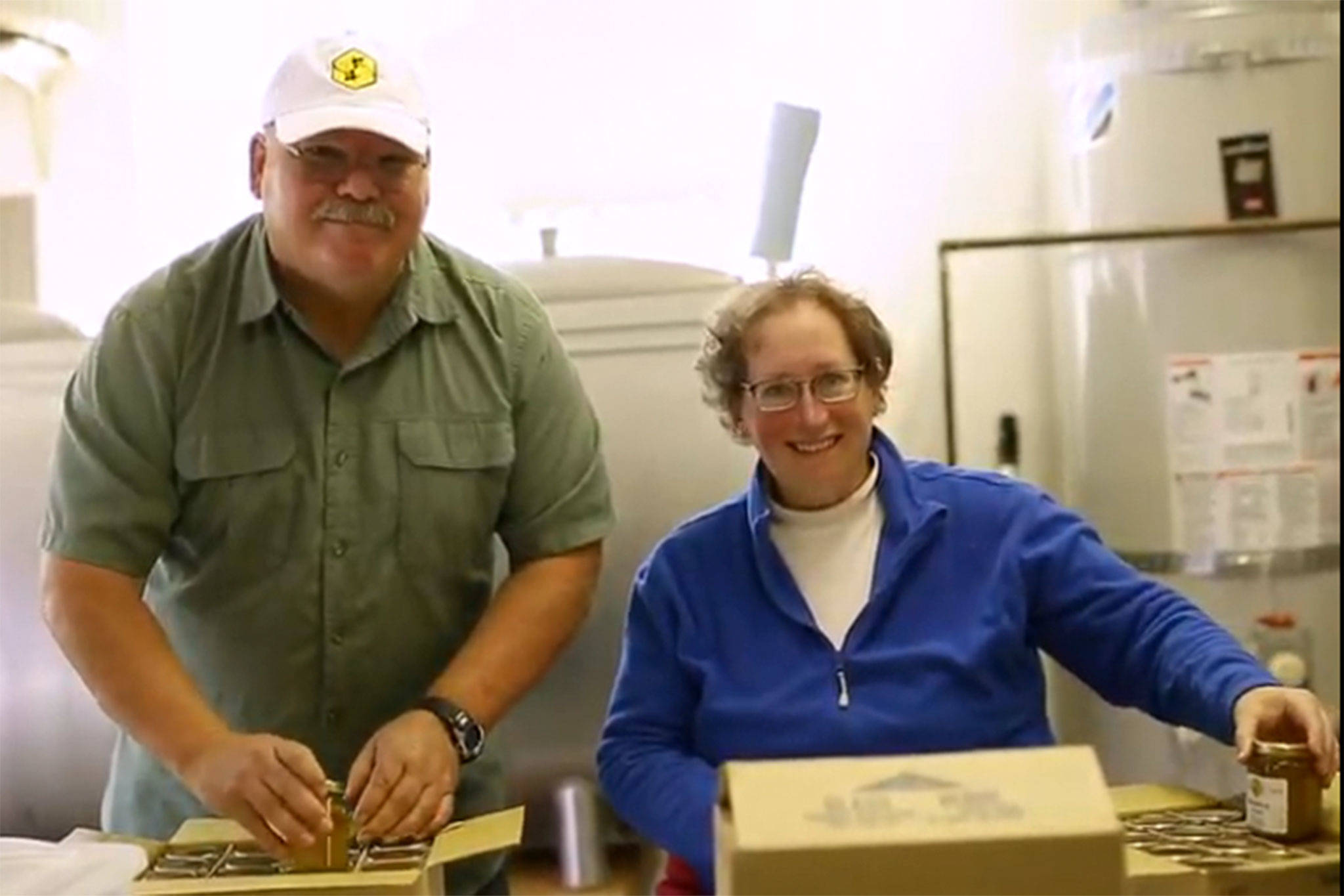Buddy and Meg DePew work in their garage finalizing orders last year, and plan to expand this year with new equipment, a kitchen and website while seeking contracts with bigger grocers in Western Washington. (Sequim Bee Farm)