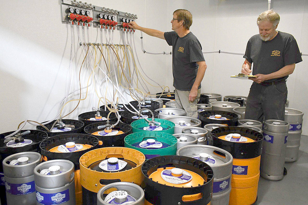 Discovery Bay Brewery’s Patrick Raymond checks the regulator pressure while Glenn Jones takes keg inventory in preparation for their first appearance at Strange Brewfest this weekend in Port Townsend. The duo, along with 32 regional brewers and 5 cideries, will offer unusual concoctions not found anywhere else to 3,000 beer aficionados through Saturday night at the American Legion Hall. (Jeannie McMacken/Peninsula Daily News)