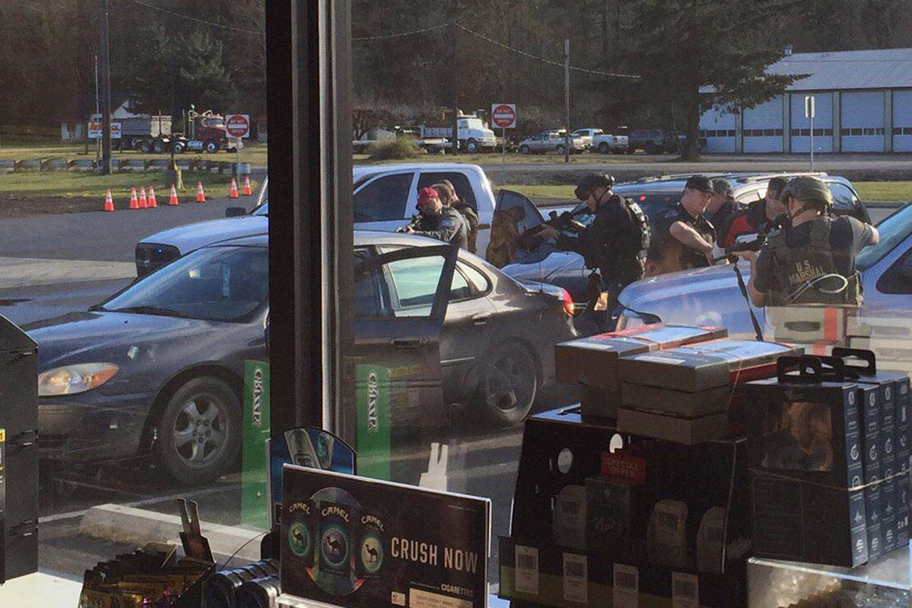 U.S. Marshals Service deputies arrest Ryan Ward at Lower Elwha Food and Fuel on Wednesday. (Jared Baker)