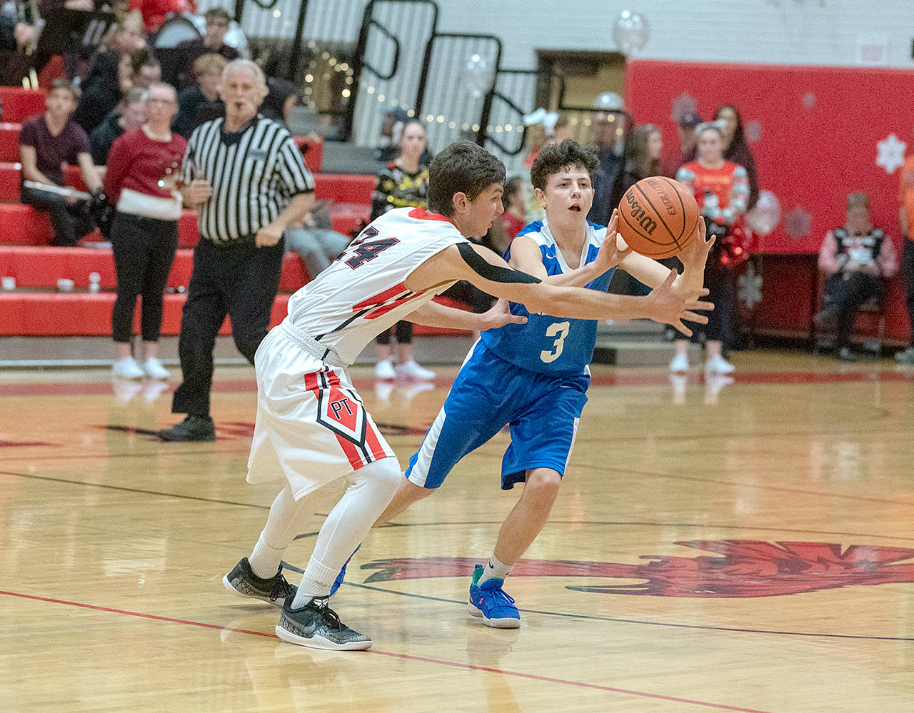 Steve Mullensky/for Peninsula Daily News Port Townsend’s Kuba Krol, 24, defends Chimacum’s Clayton Smith during a game earlier this season.