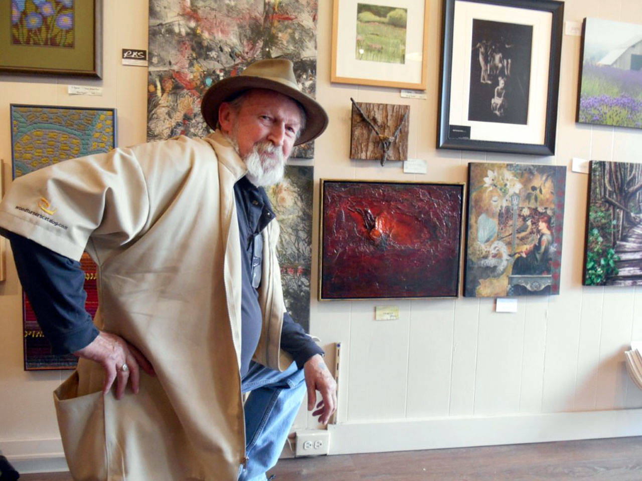 Tracy McCallum poses with paintings at Harbor Art Gallery. The featured artist of the month at the gallery on Laurel Street in Port Angeles, McCallum will be on hand during the Second Saturday Art Walk.