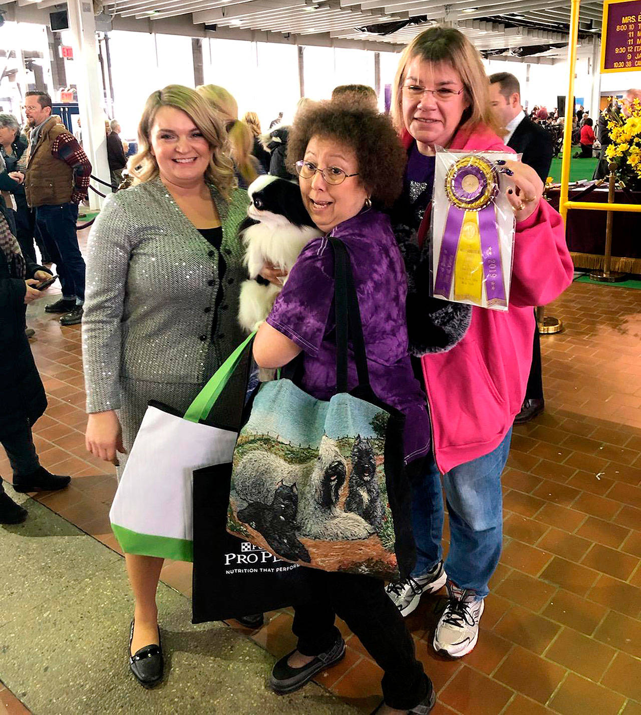 From left, Diznee’s handler Rowan Baggenstos, co-owner Mariko Saum and co-owner Dawn Shaffett celebrate winningBest of Breed at the Westminster Dog Show in New York City.