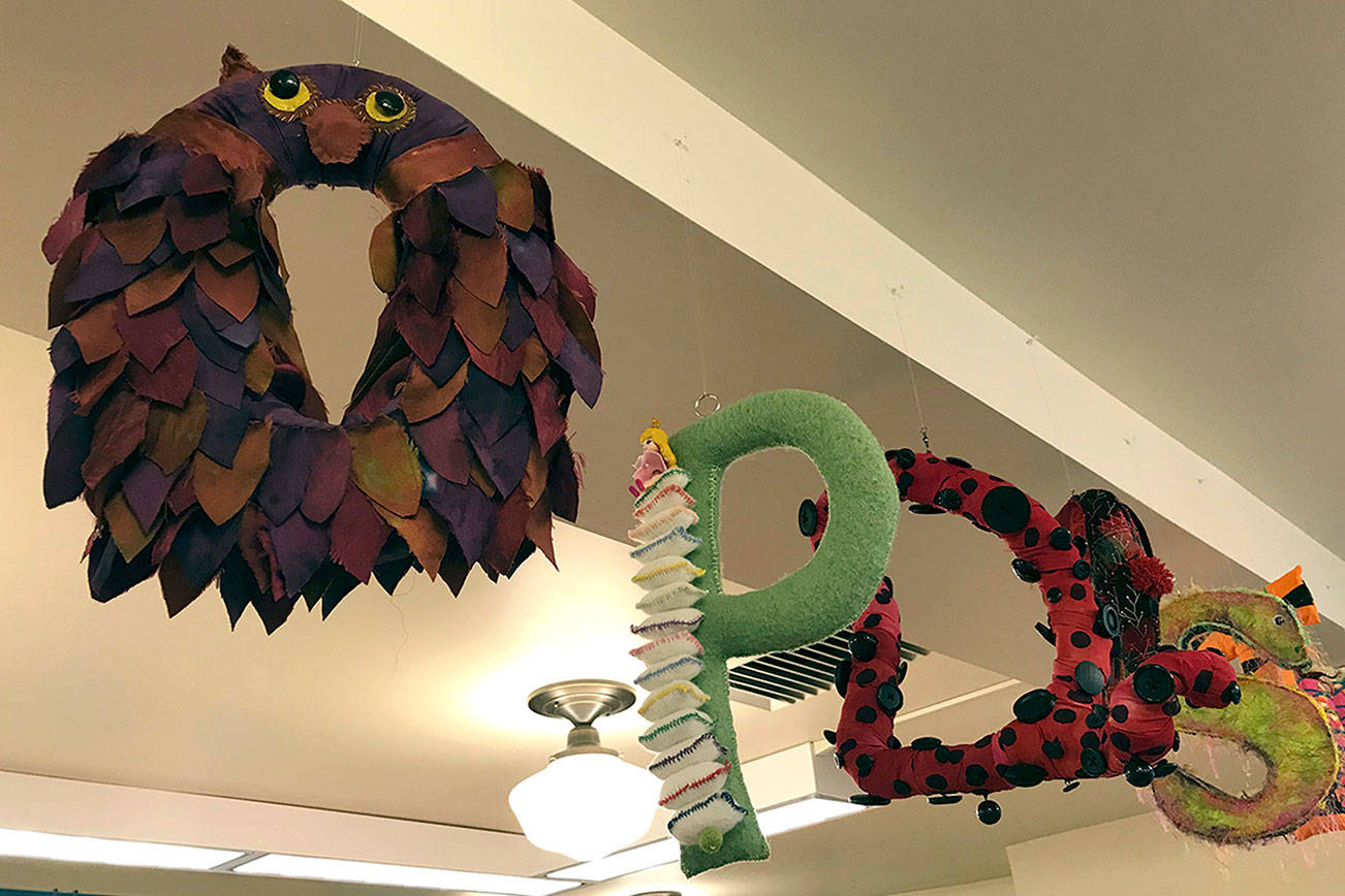 Singing welcome under floating library alphabet