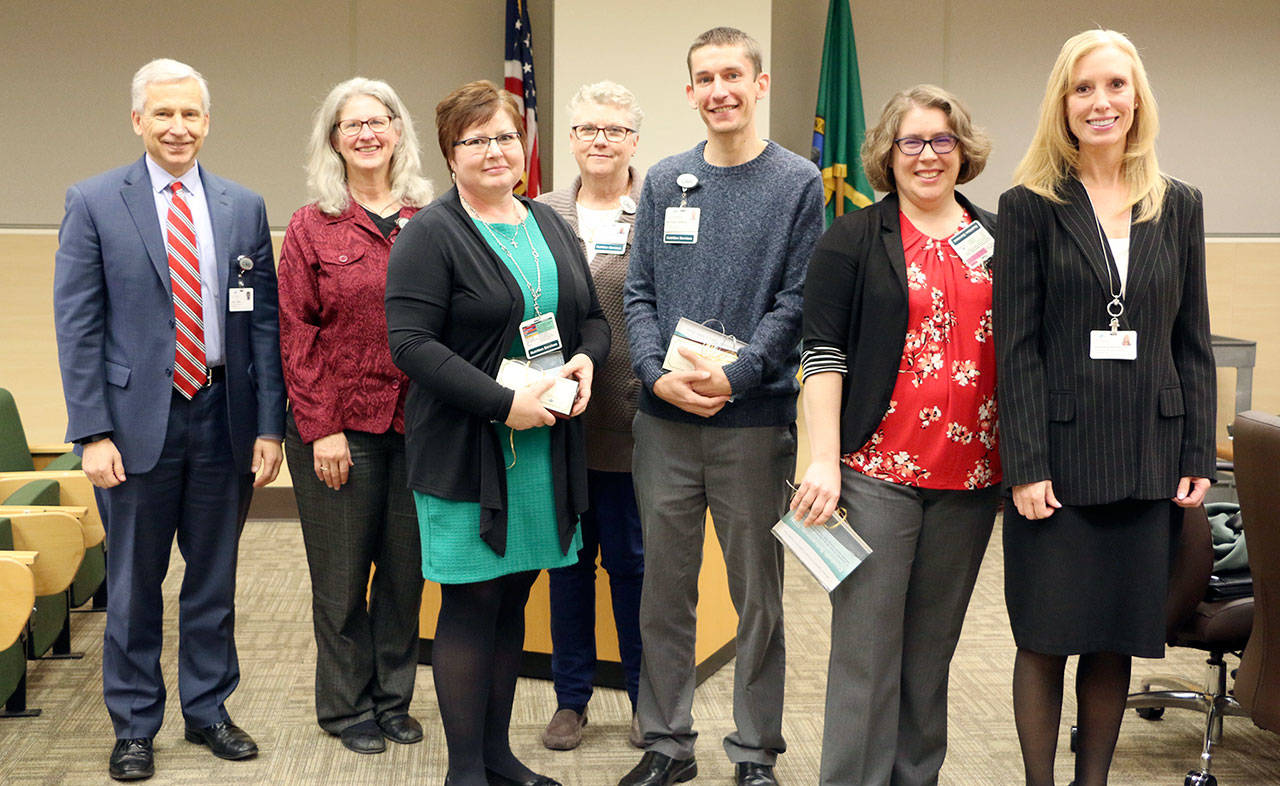 Pictured, from left, are Olympic Medical Center CEO Eric Lewis, Donna Pacheco, Lori Spink, SueTalbert, Michael Lessor, Elizabeth Schuerman and Jennifer Burkhardt.
